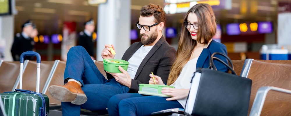 Couple eating healthy food at an airport