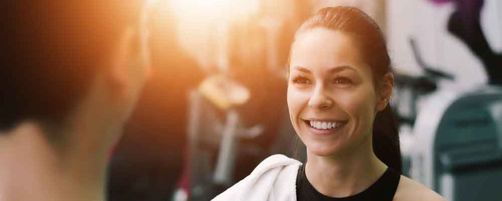 woman talking to fitness trainer