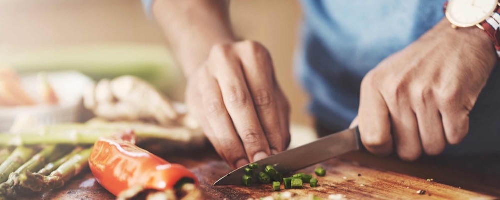 Man preparing healthy food in the kitchen
