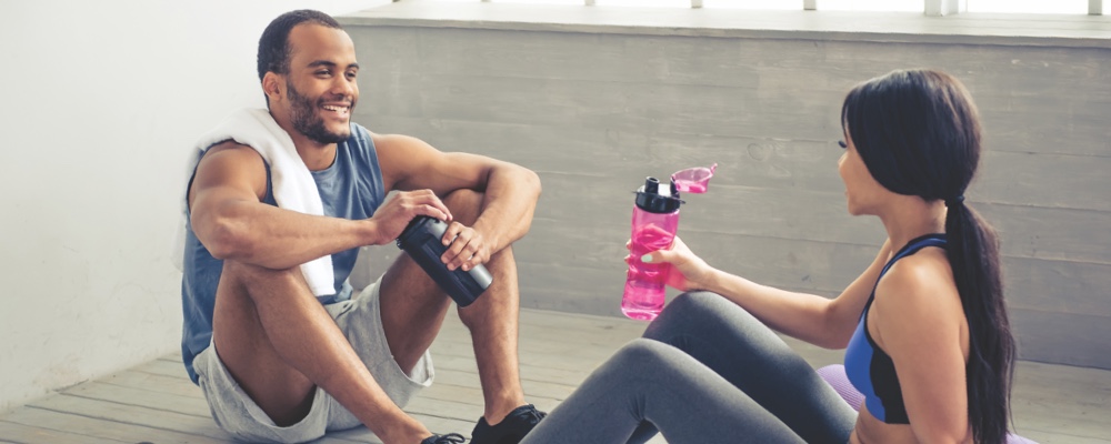 Couple sitting together recovering after workout