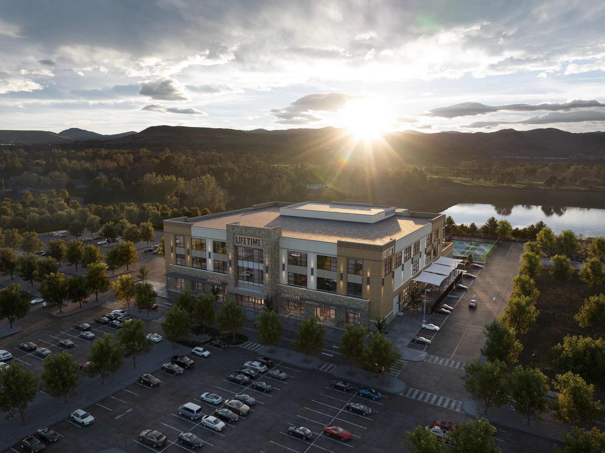 An aerial shot of the exterior of Life Time Denver West with the sunset and mountains in the background.