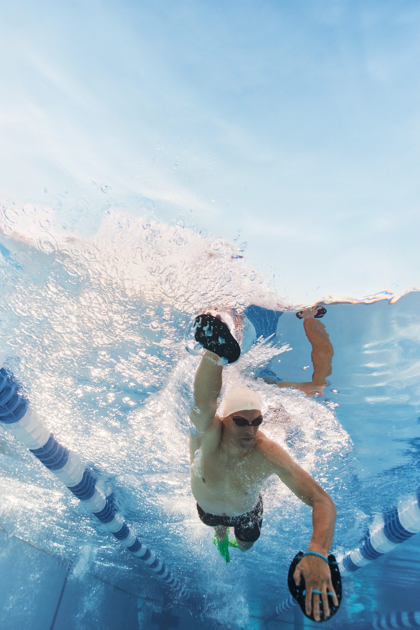 man swimming underwater in a pool