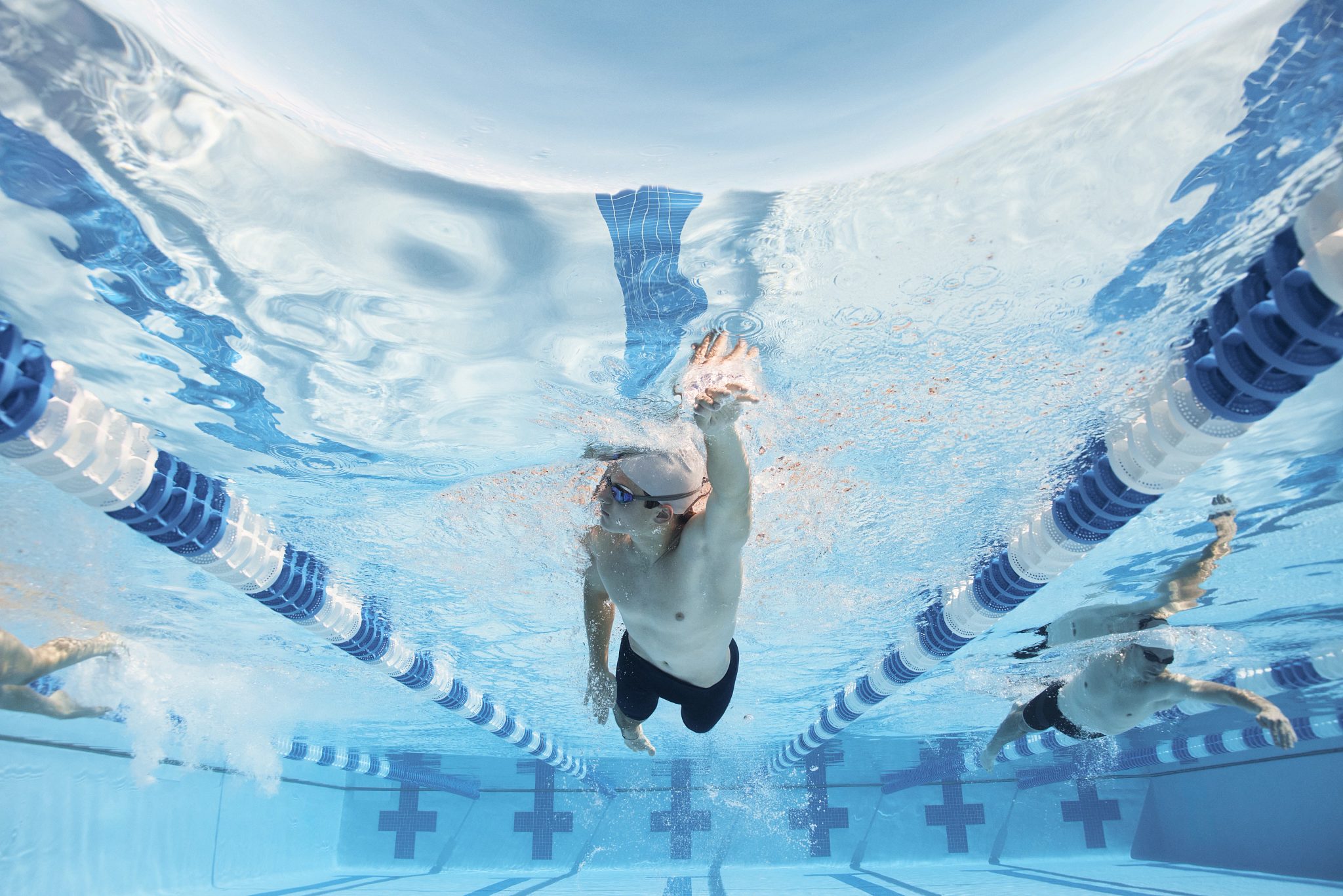 man doing swimming in a lap pool