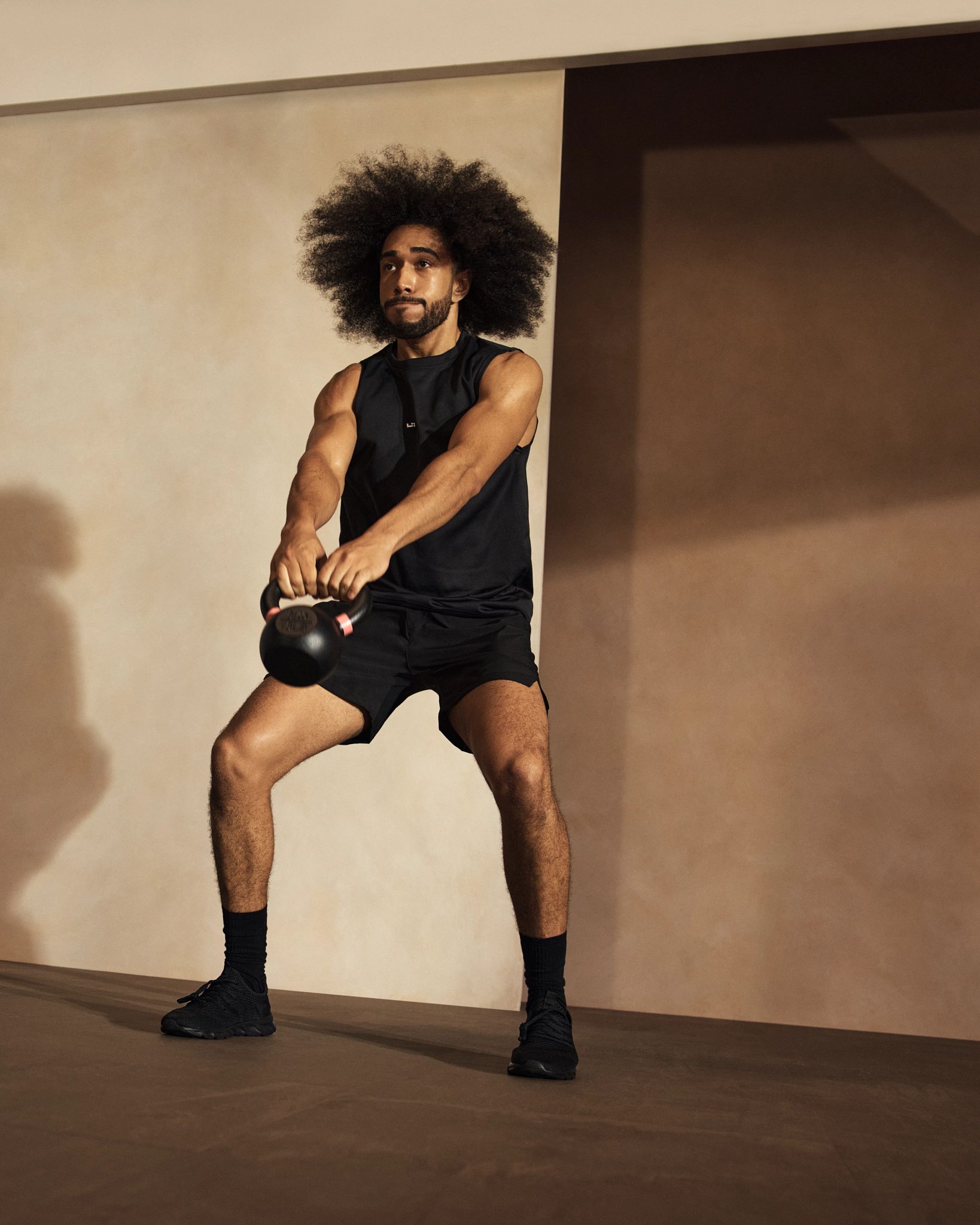 Alpha class participant working out with a kettlebell