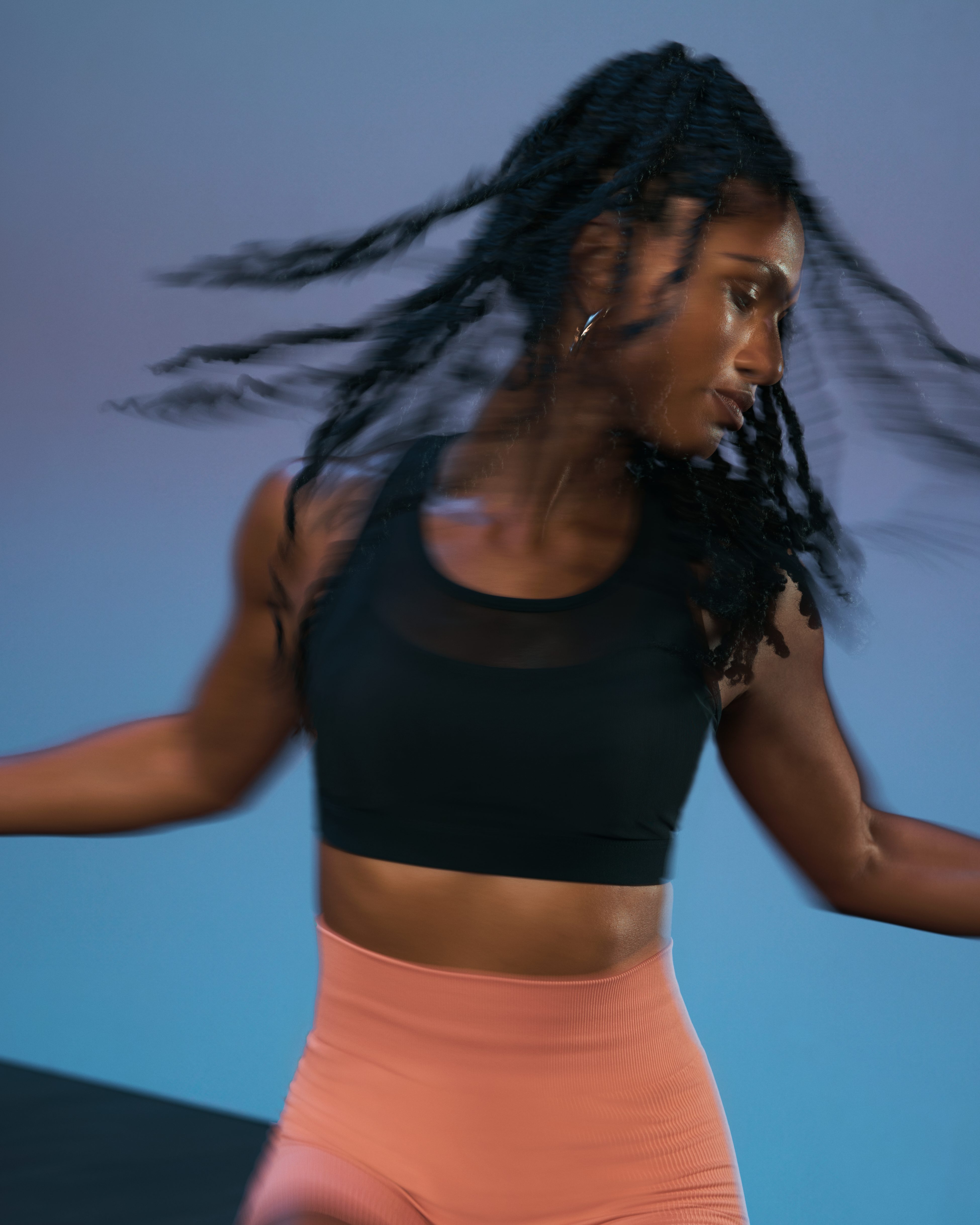 Close up of a Life Time member in motion during the sculpt portion of an AMP spin class