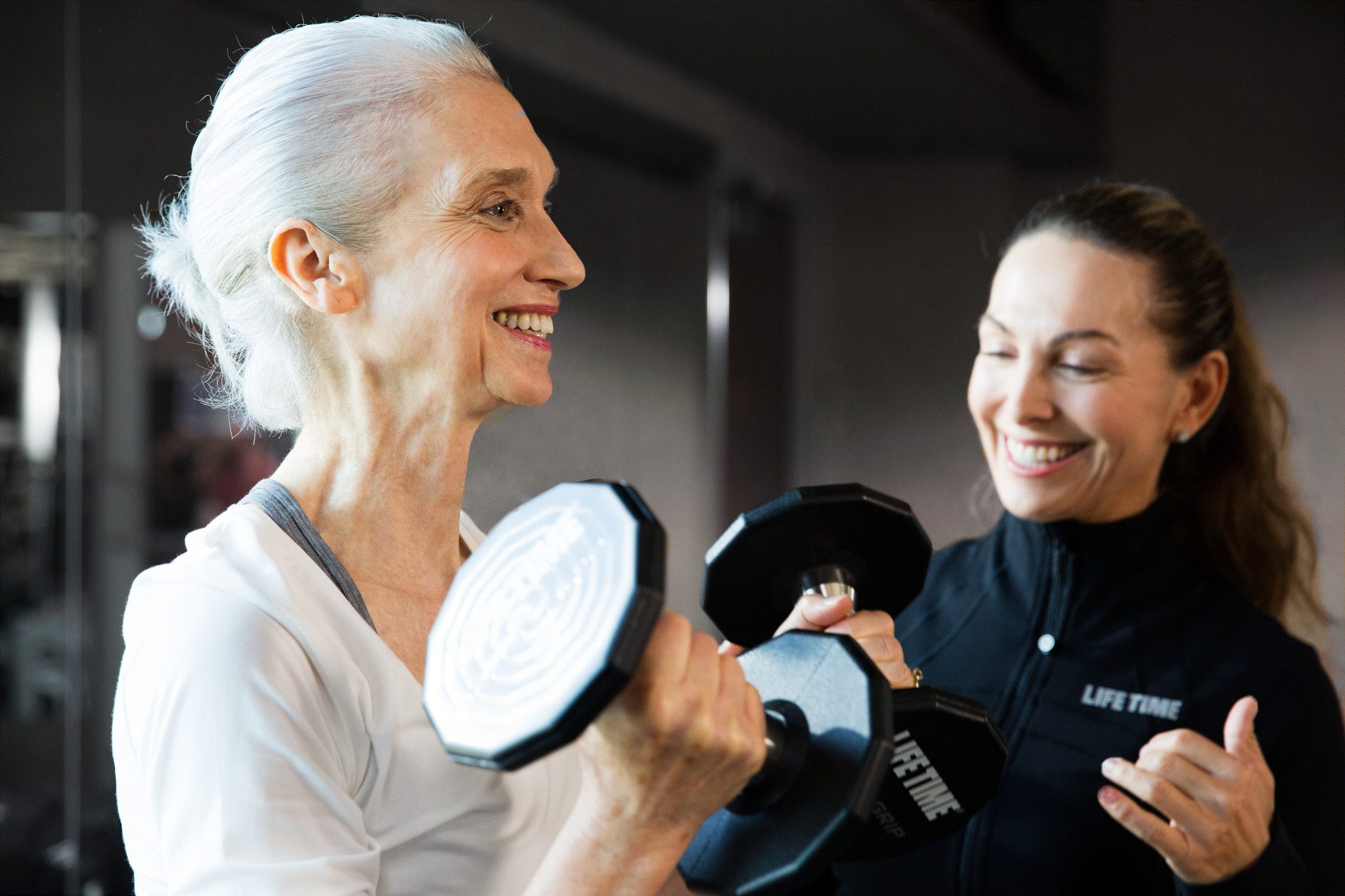 Female doing bicep curls during a personal training session.