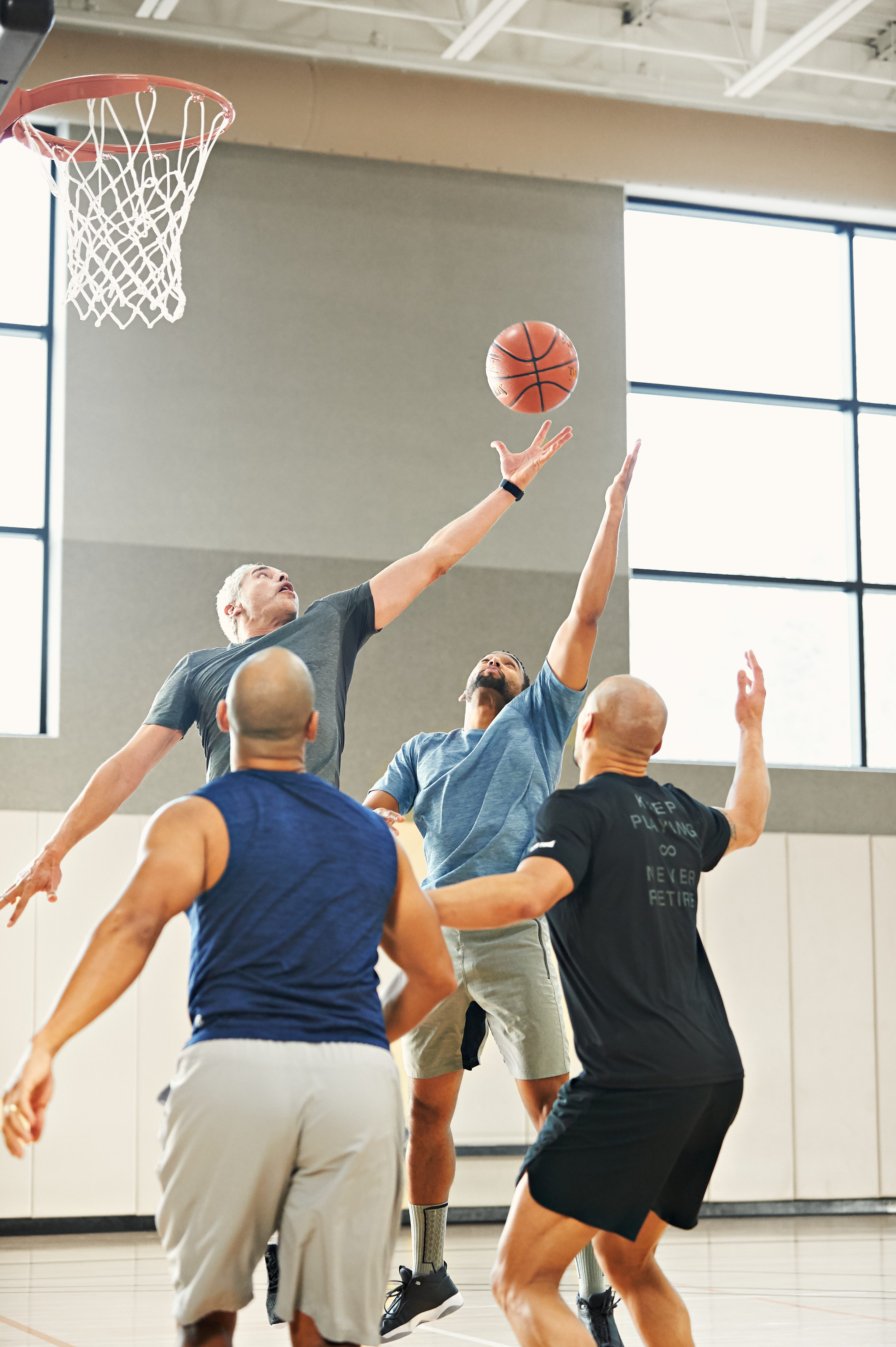 group of male playing a pickup game and jumping in the air