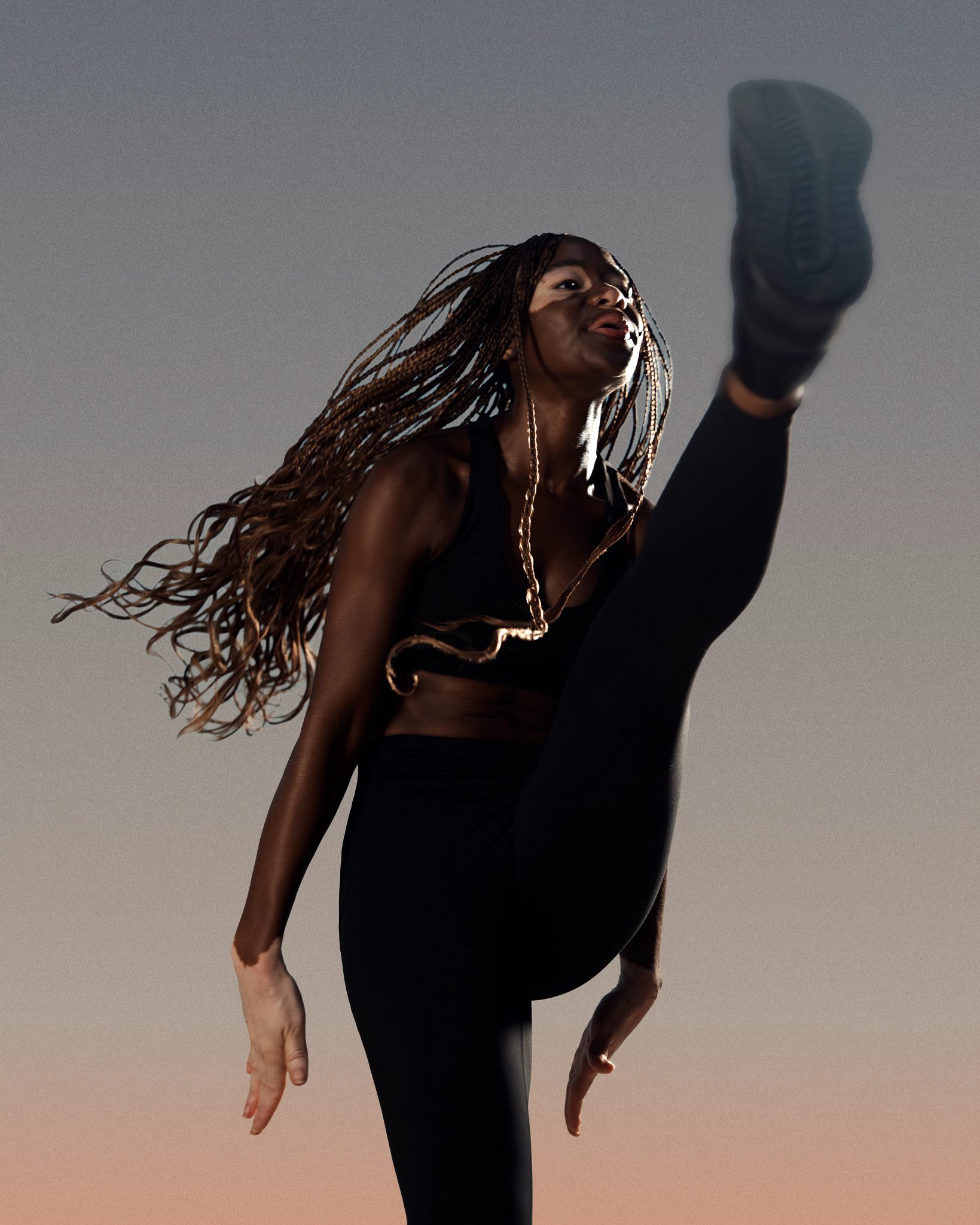 Burn cardio class participant doing a high kick at Life Time