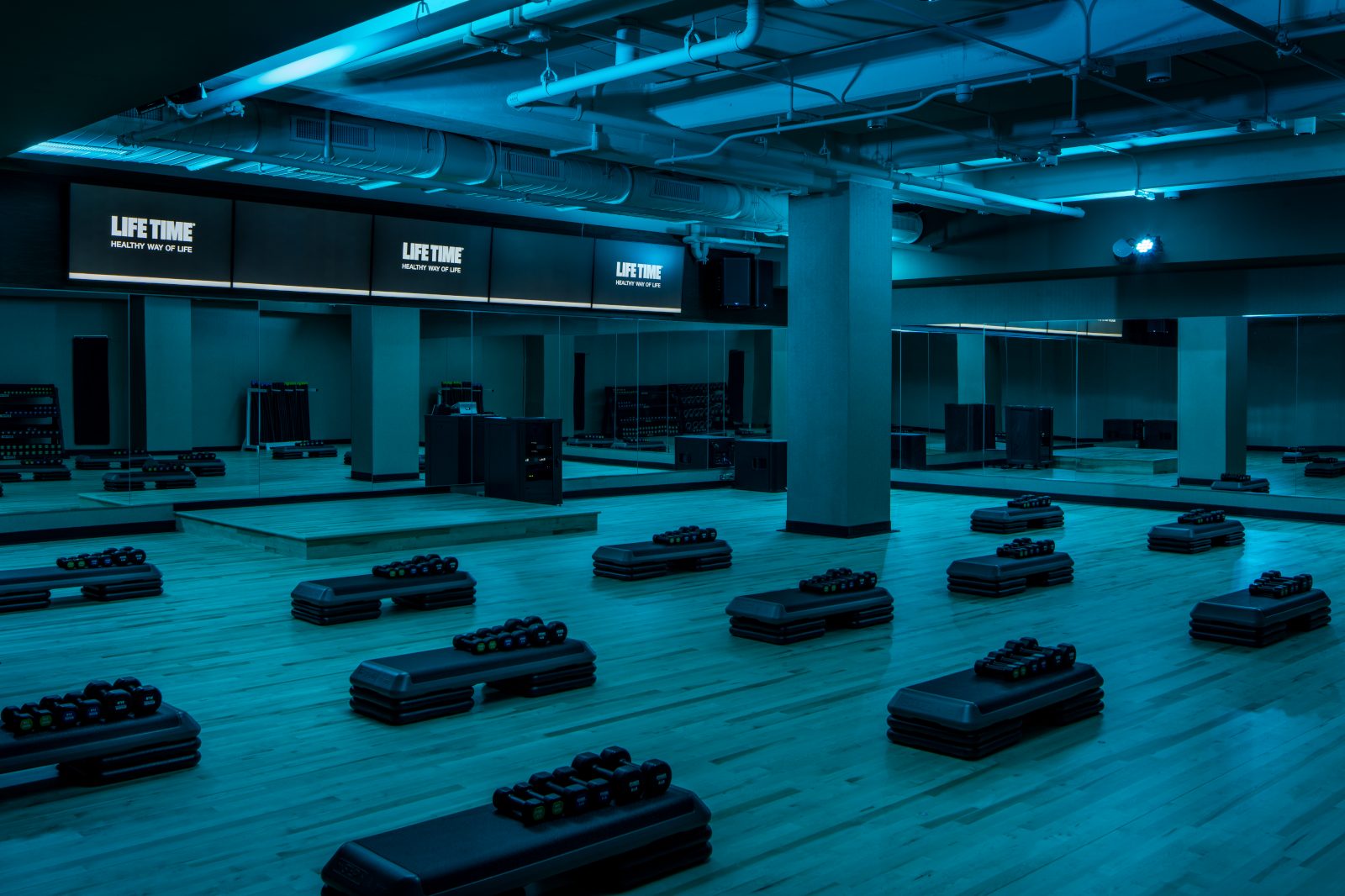 Group Fitness Studio lit in blue at the Life Time One Wall Street club