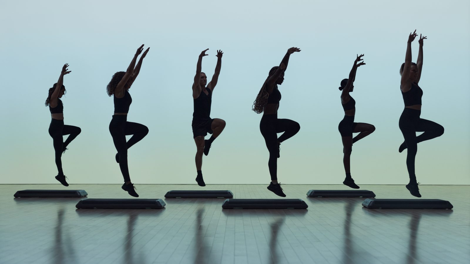 Remixx cardio dance class featuring silhouettes of people arms extended overhead in dance