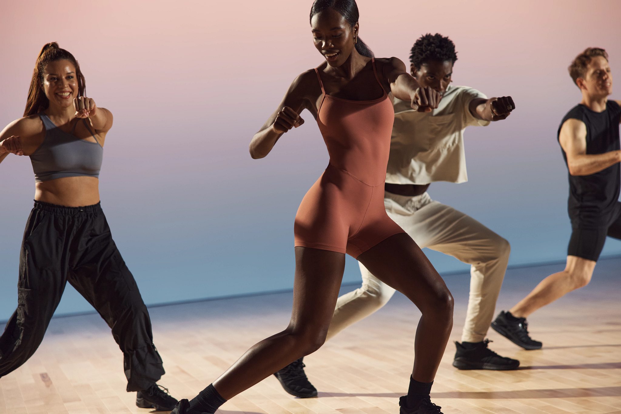 Danze class participants in various positions at Life Time