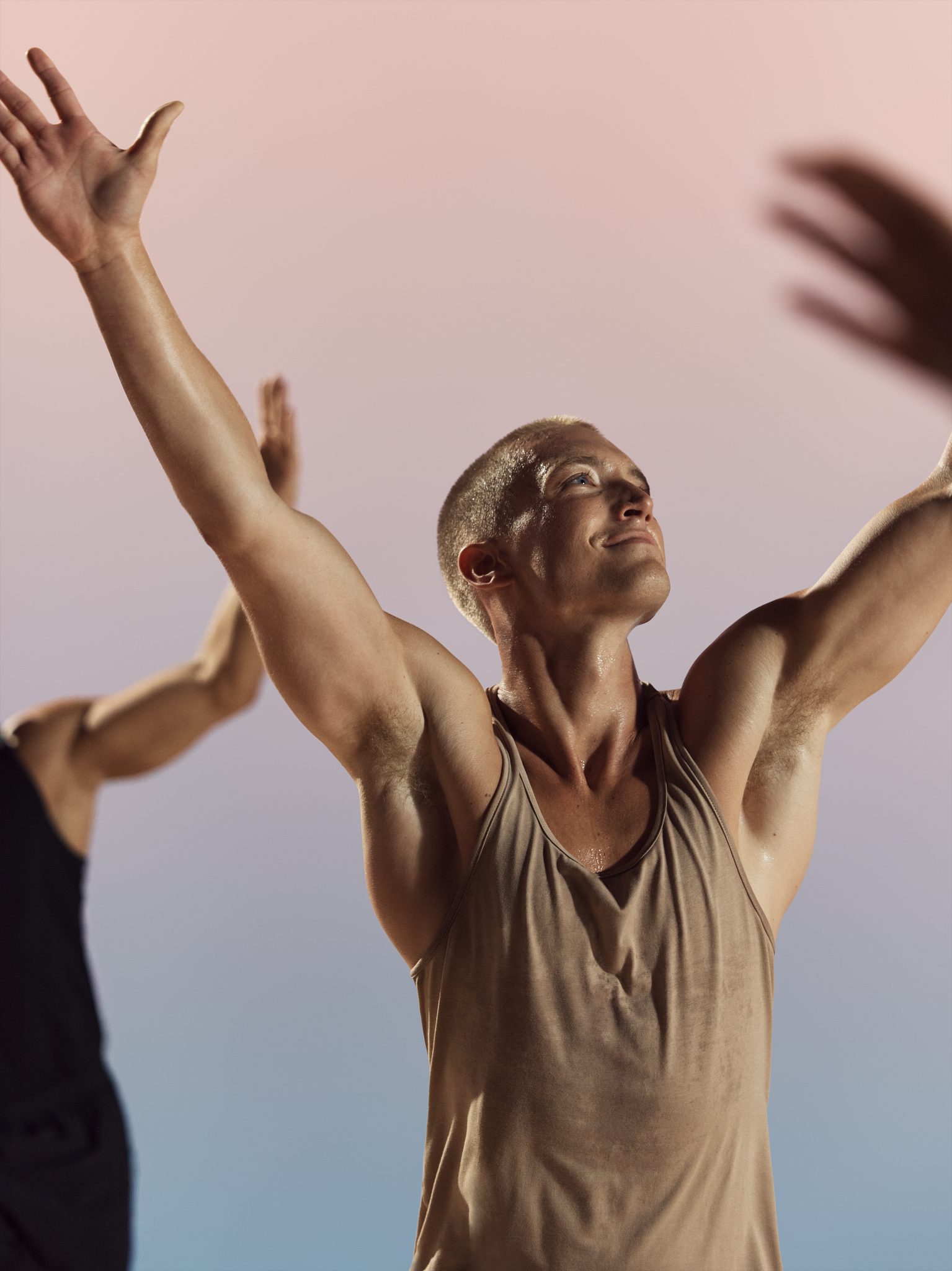 Danze class participants with arms raised at Life Time