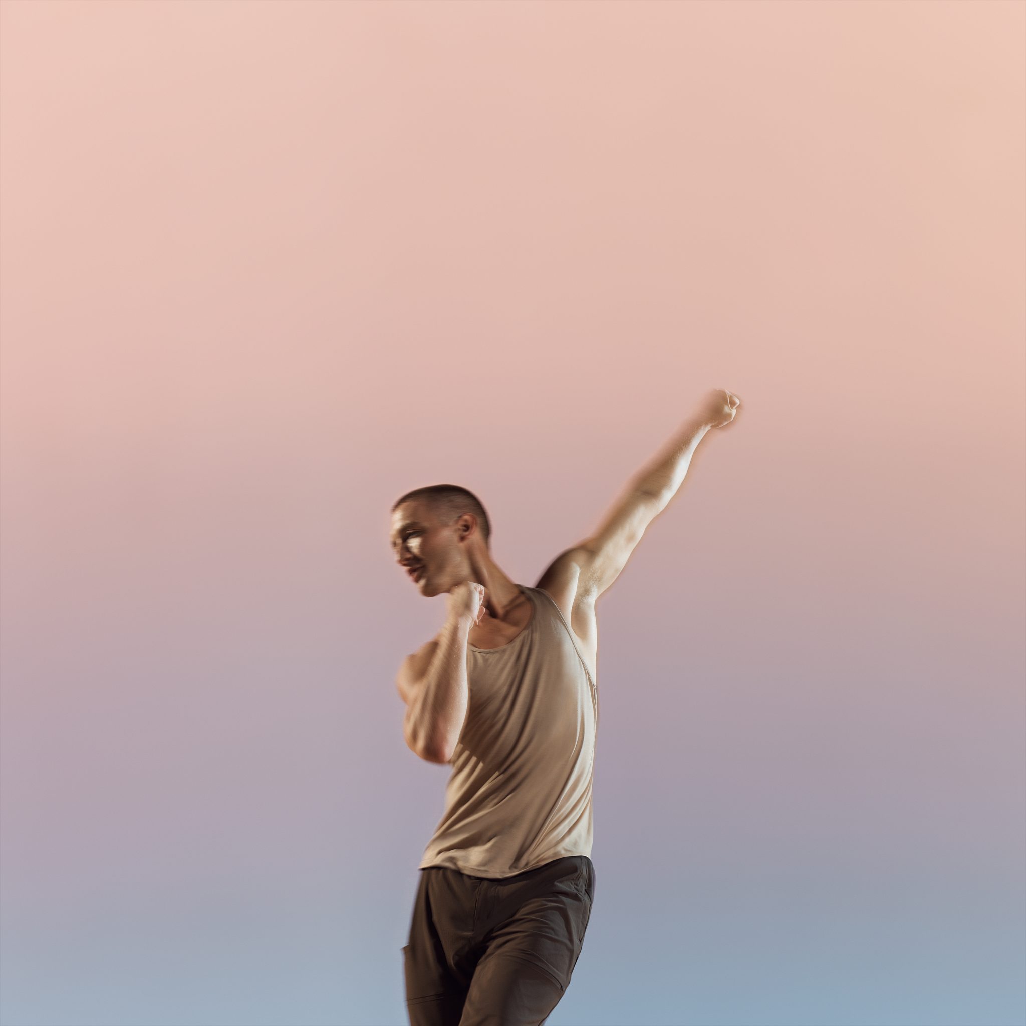 Danze class participant with arm extended above head at Life Time