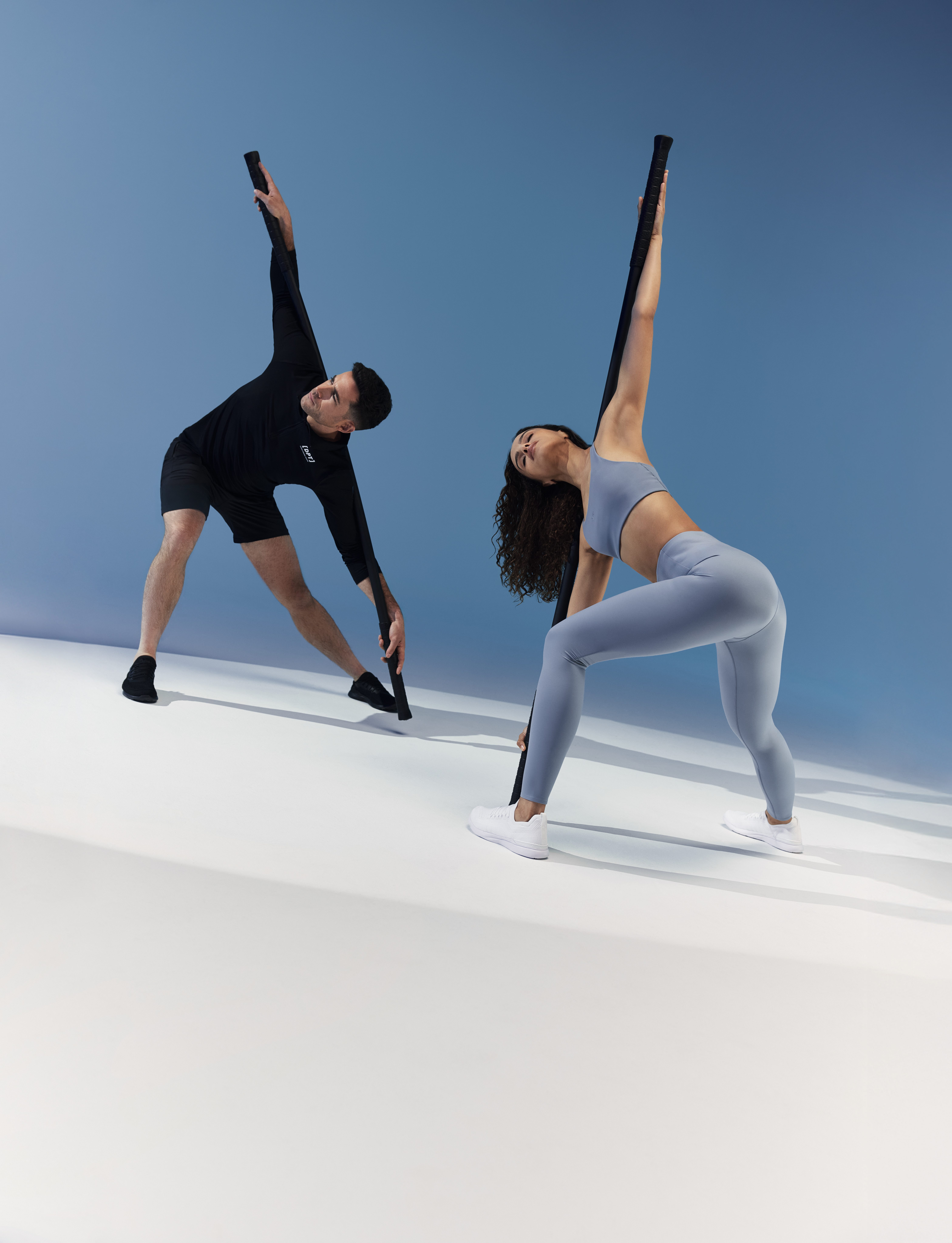 A client and trainer using weighted bars during a Dynamic Personal Training session