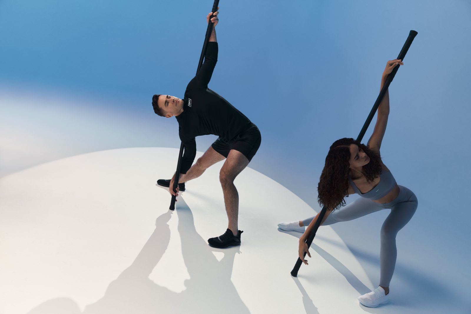 A client and trainer using weighted bars during a Dynamic Personal Training session