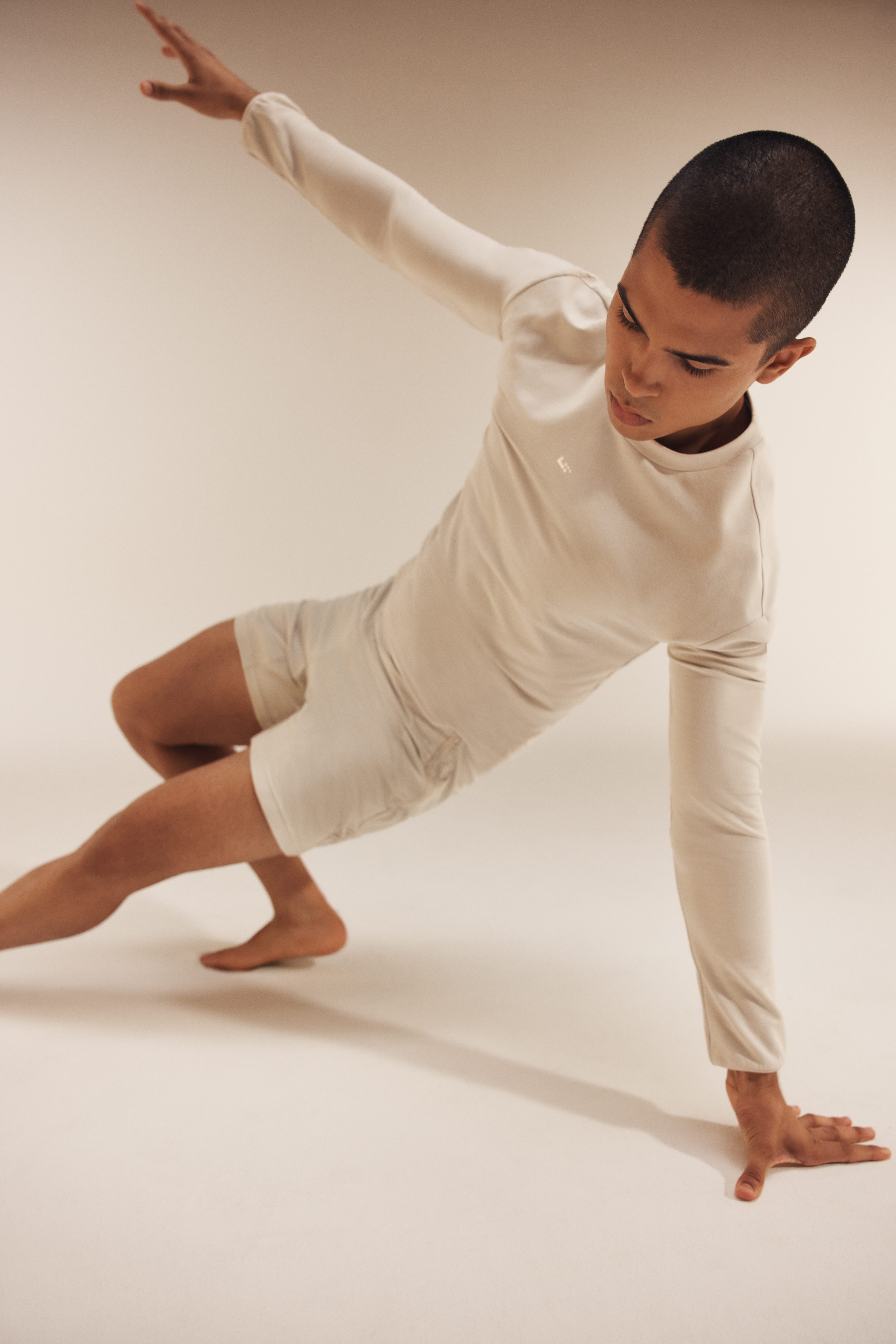 Portrait of an adult male in a side-plank position balancing on one arm