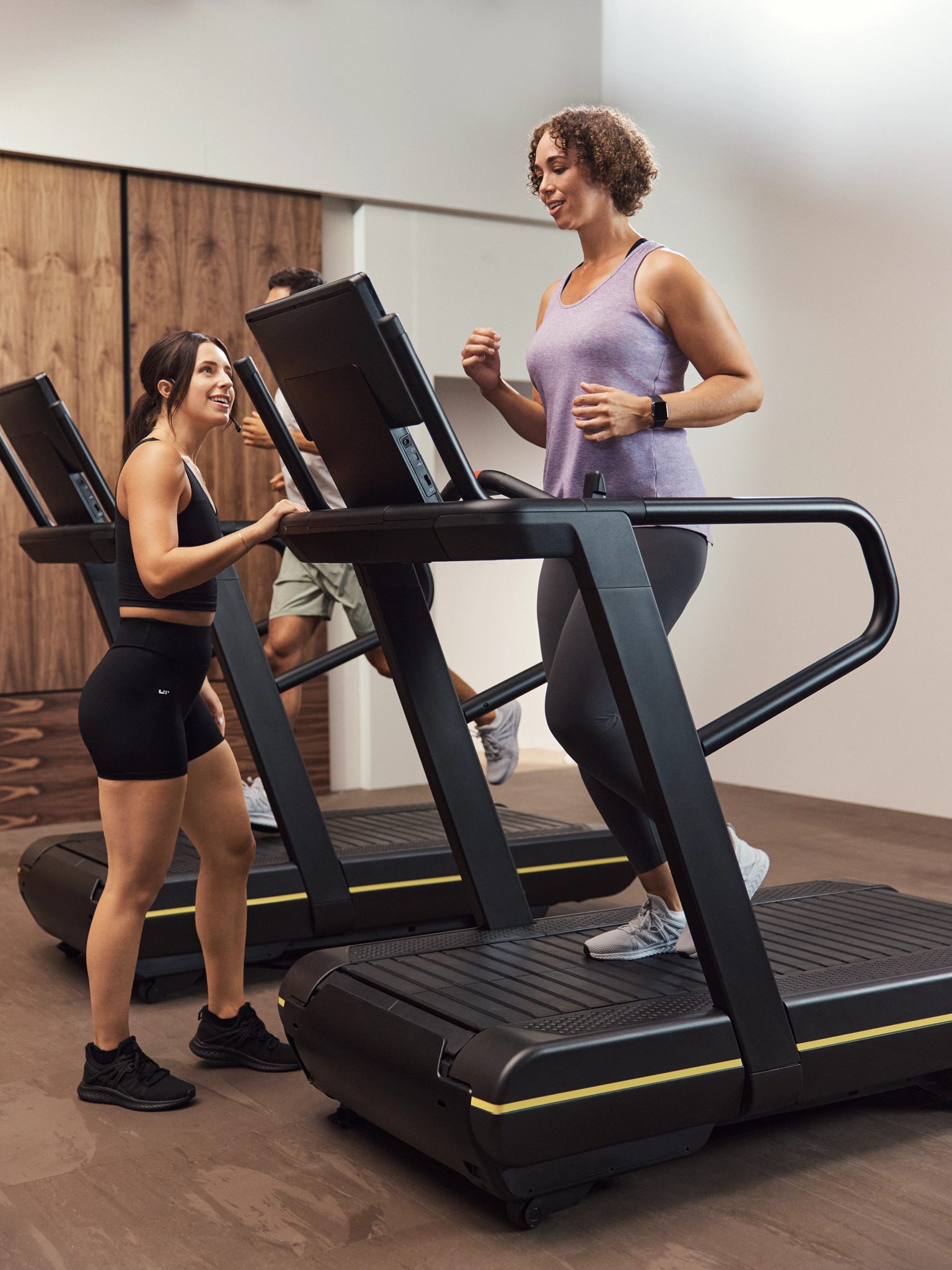 GTX instructor encouraging class member on treadmill
