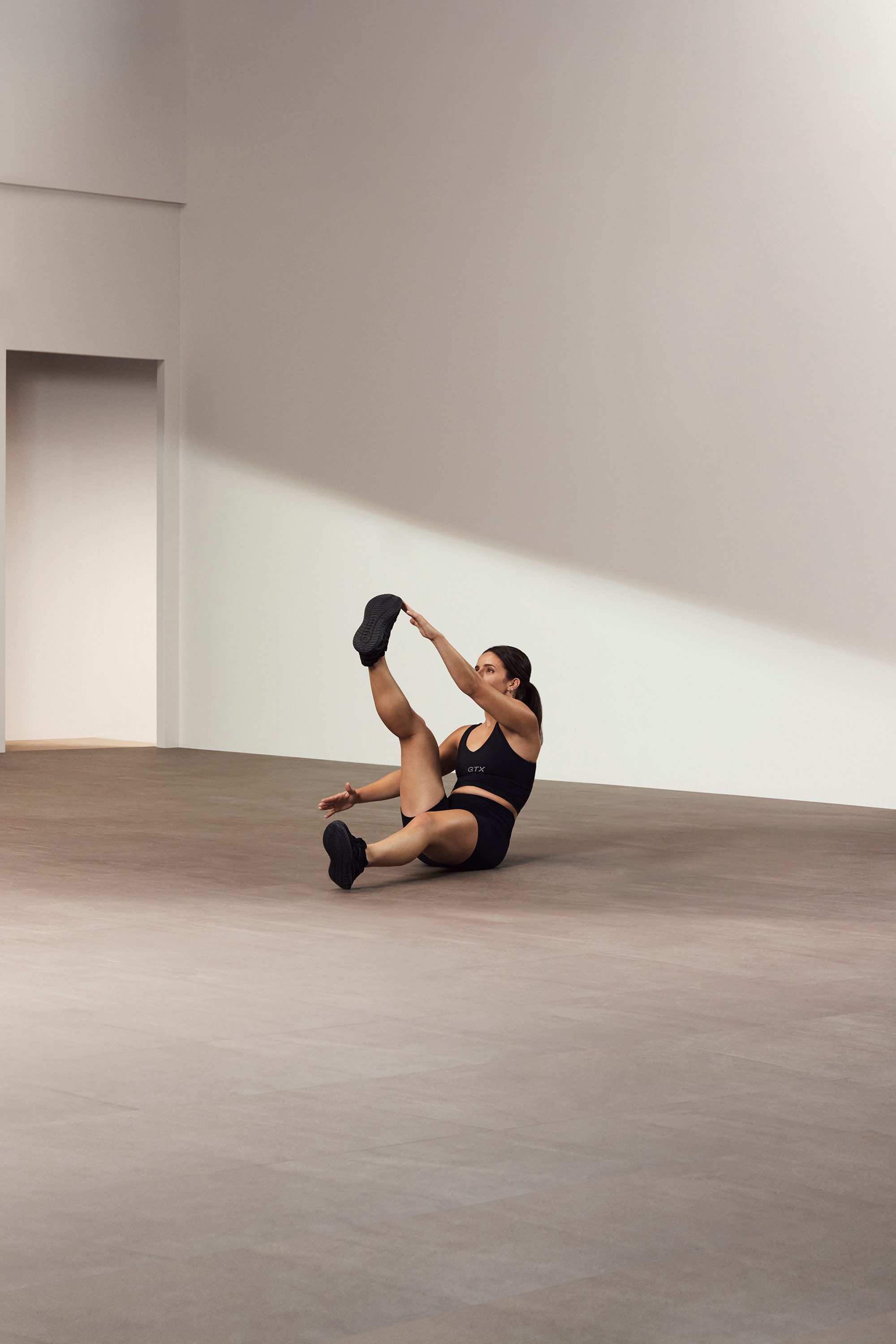 A Life Time GTX instructor demonstrating a single leg V up