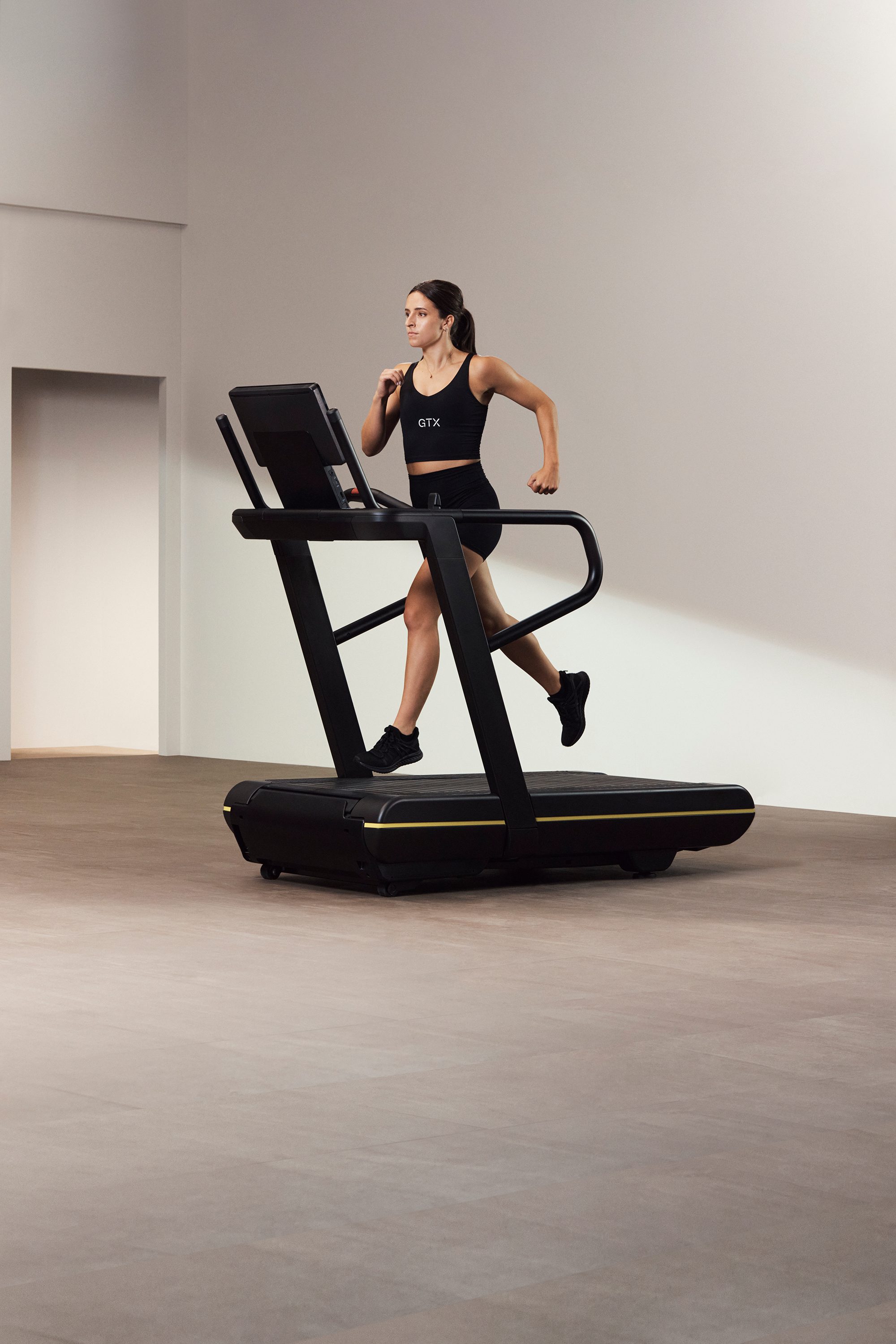 An instructor running on an elliptical