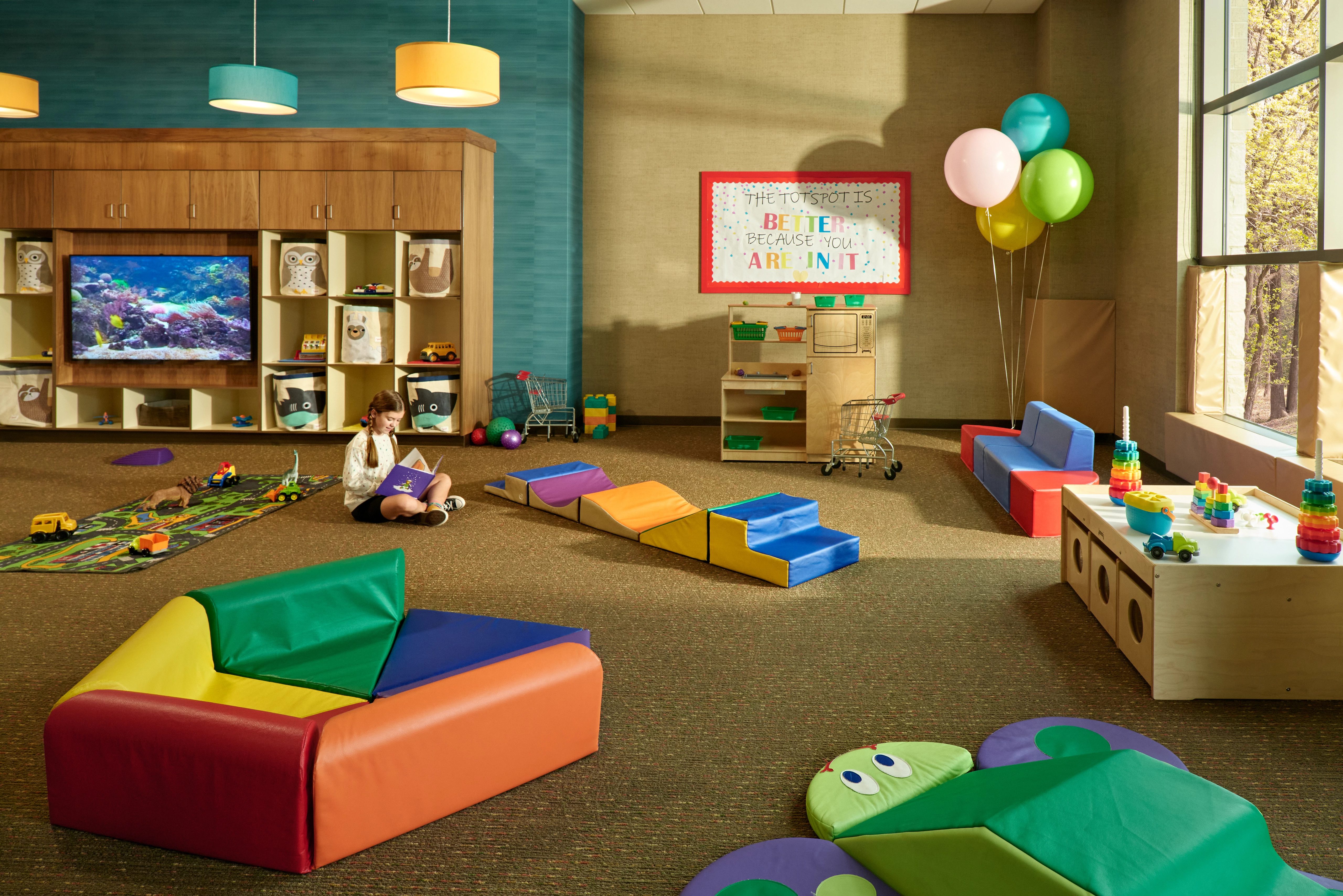 Toddler area with brightly colored toys in a Life Time Kids Academy