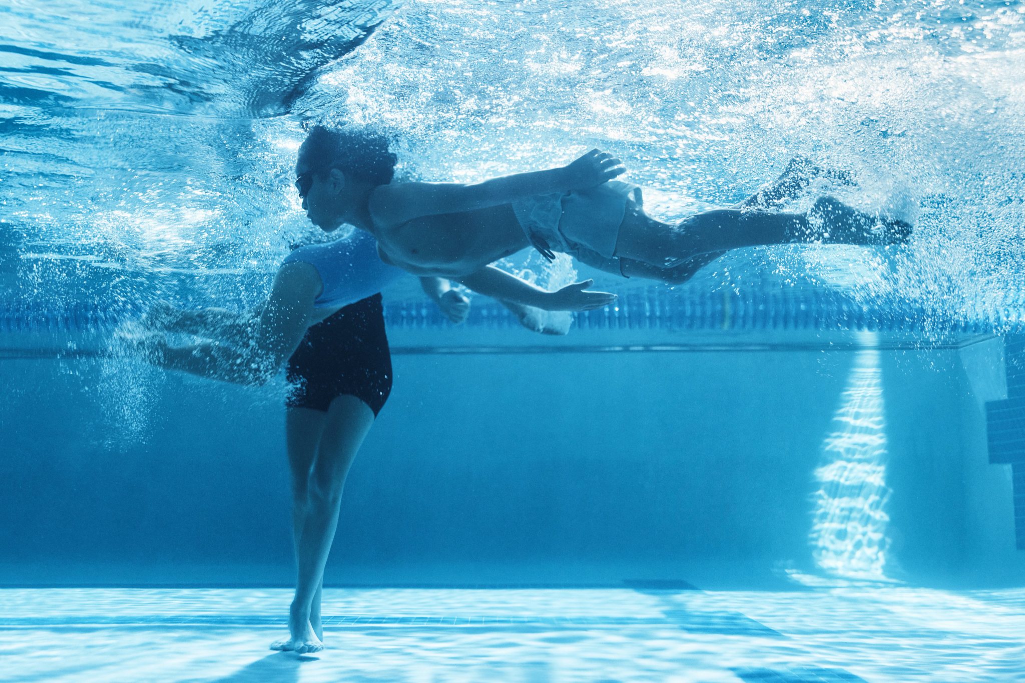 a girl holding her breath under water