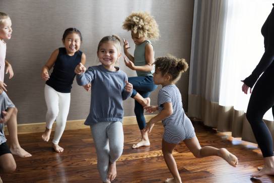 Young children smiling and dancing during a Life Time Kids Academy dance class