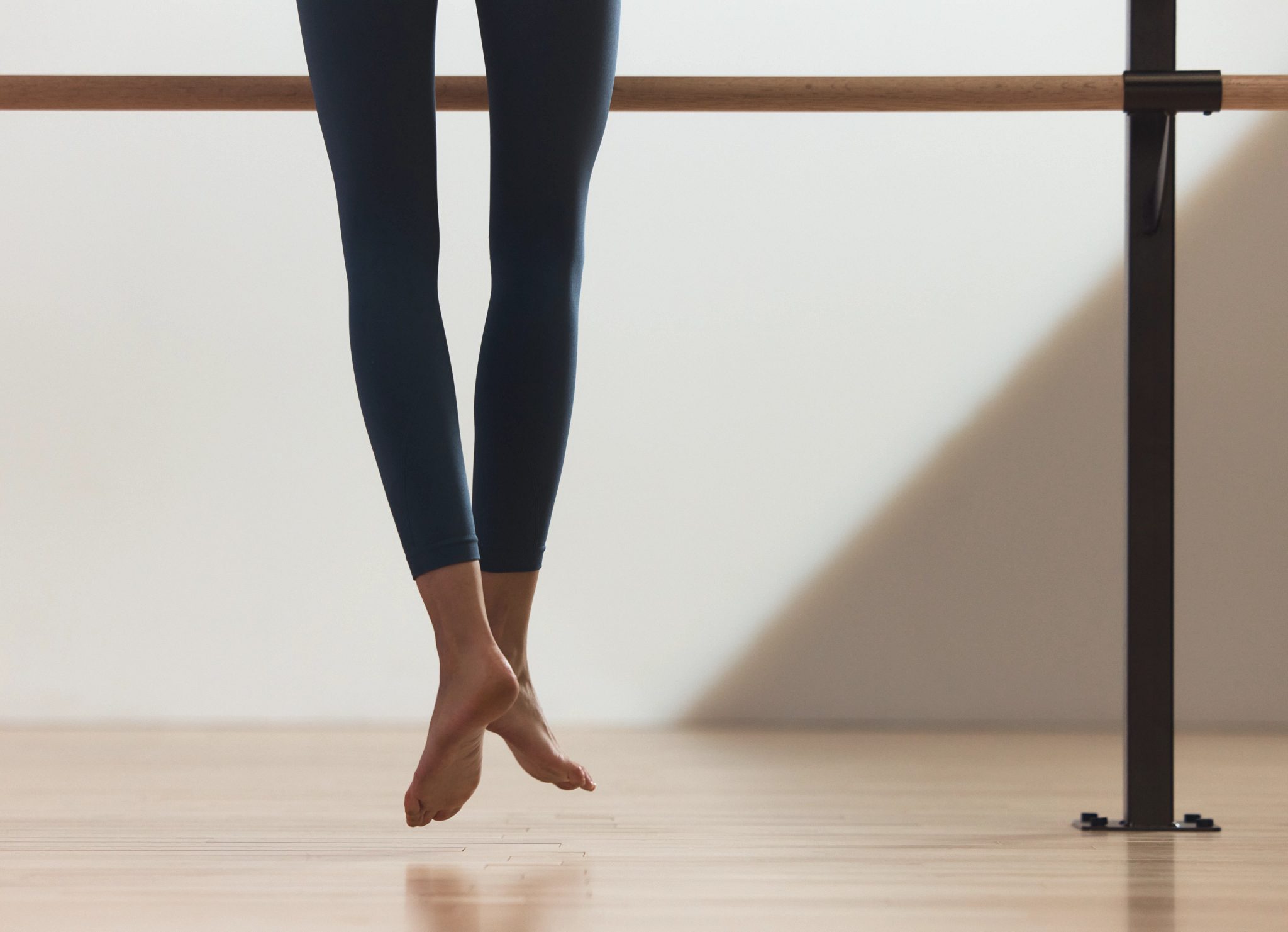Life barre class participant doing saute jump at Life Time