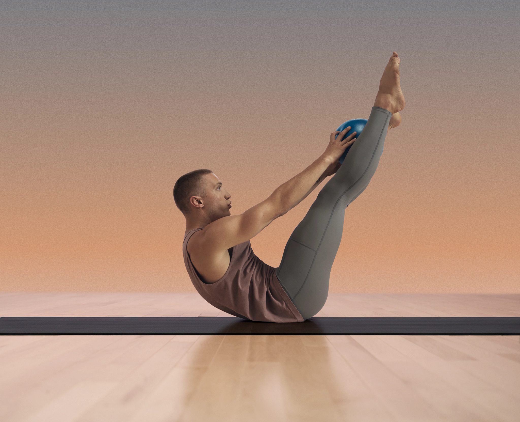 MAT Core class participant on floor in v up position at Life Time