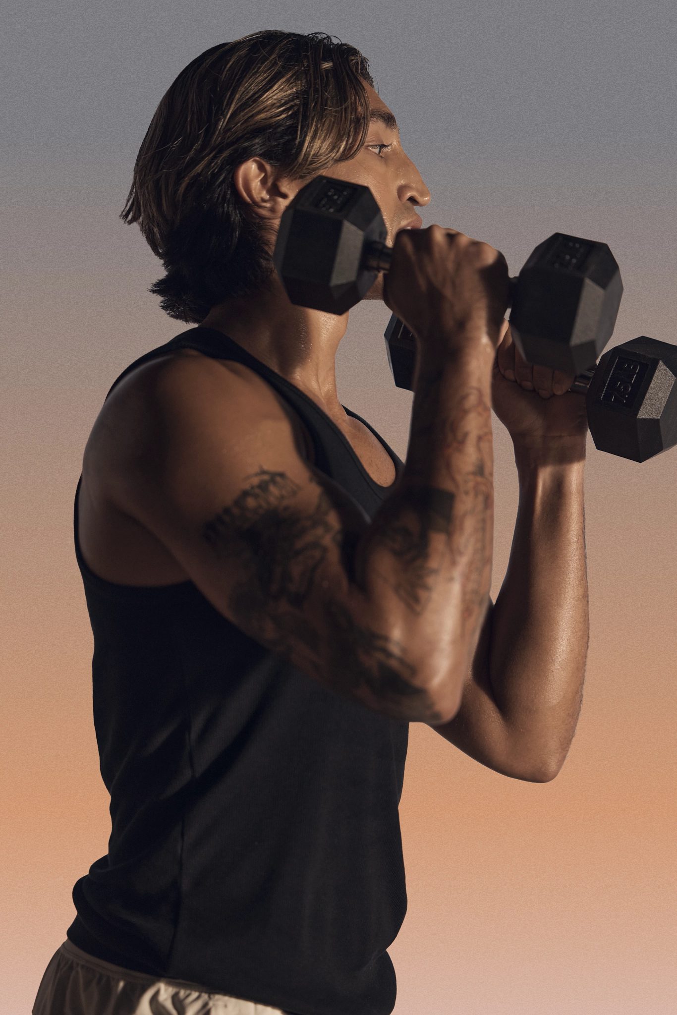 A particpant in a MAT Fusion class doing hammer curls with dumbbells