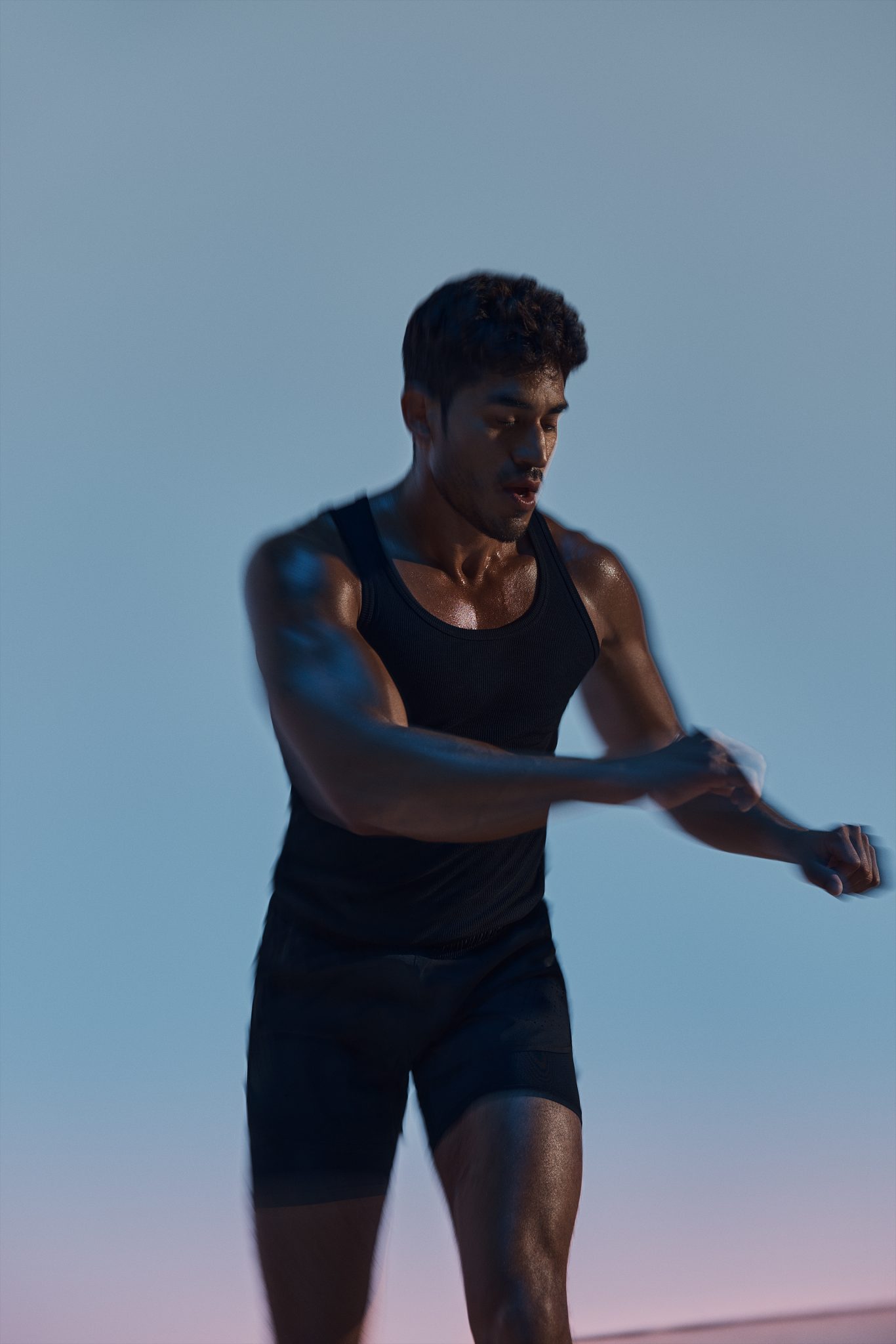 A person holding their forearm in a maxout strength class at Life Time