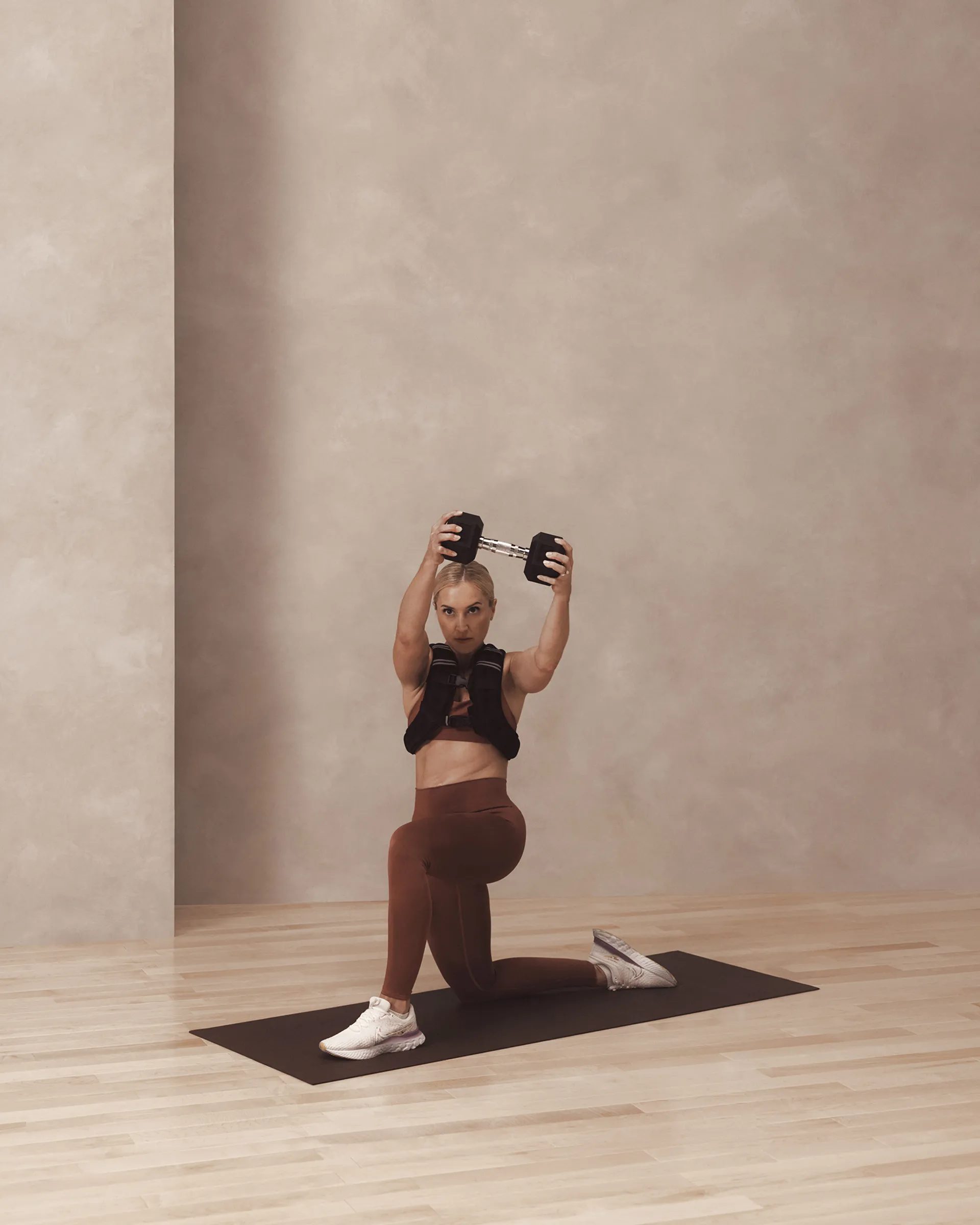 a woman in a knelling chop pose