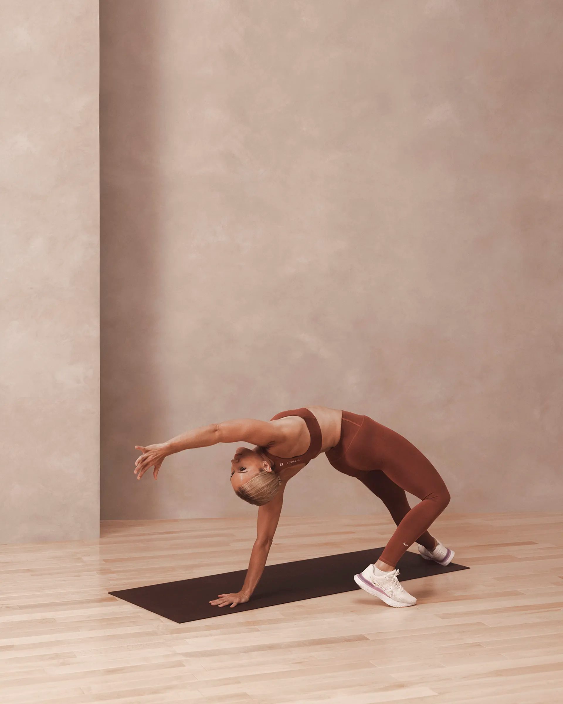 a woman in a scorpion roll pose