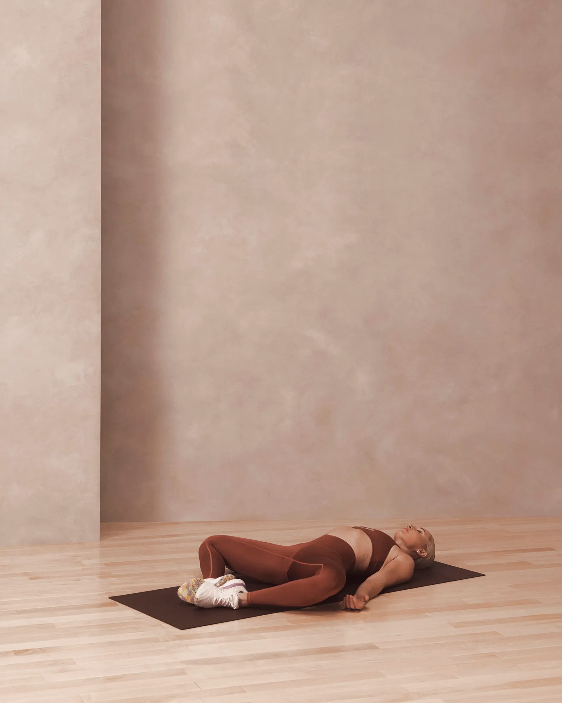 a woman laying in supine butterfly pose