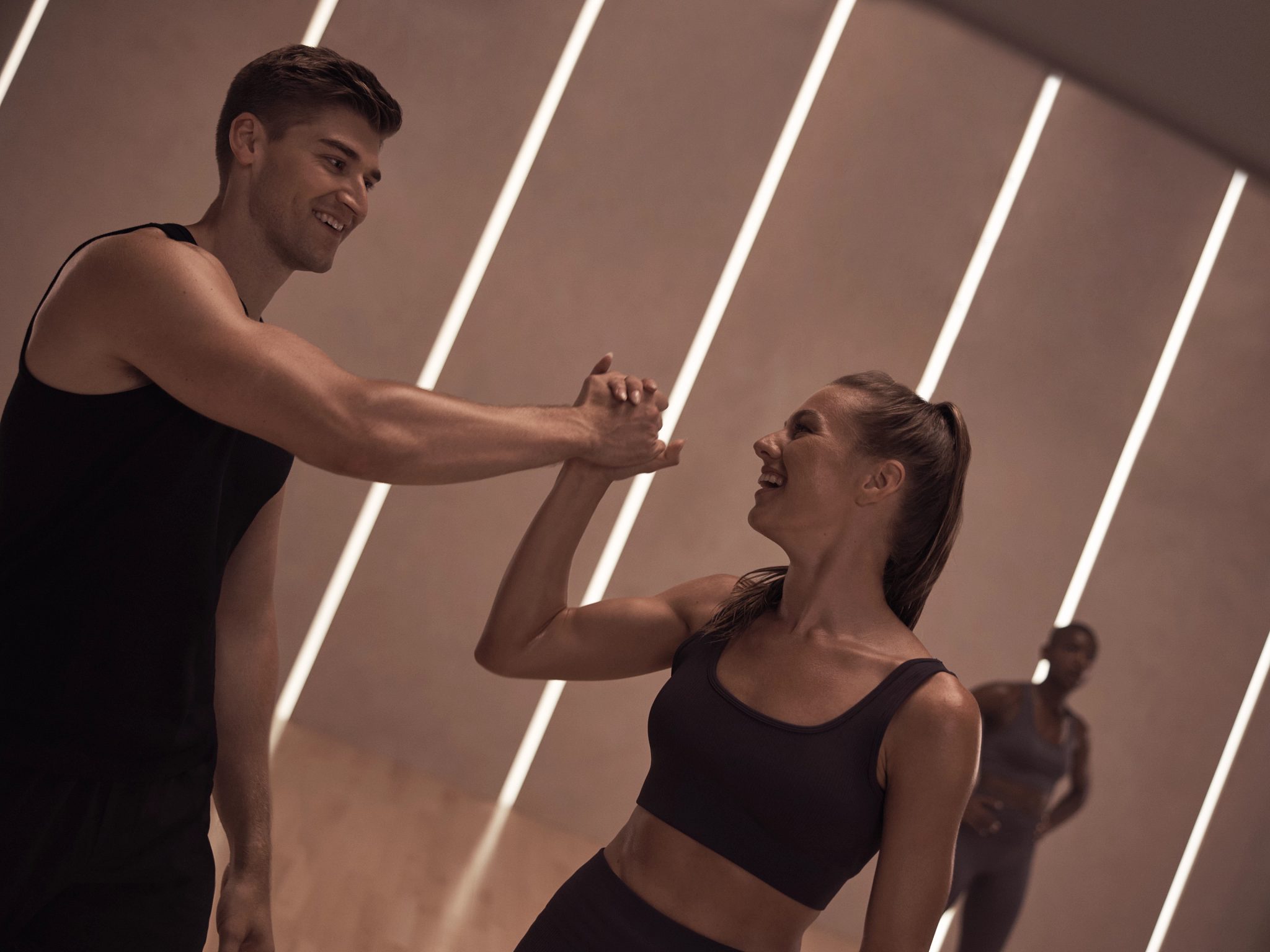 MB360 boutique group training class with two members congratulating each other