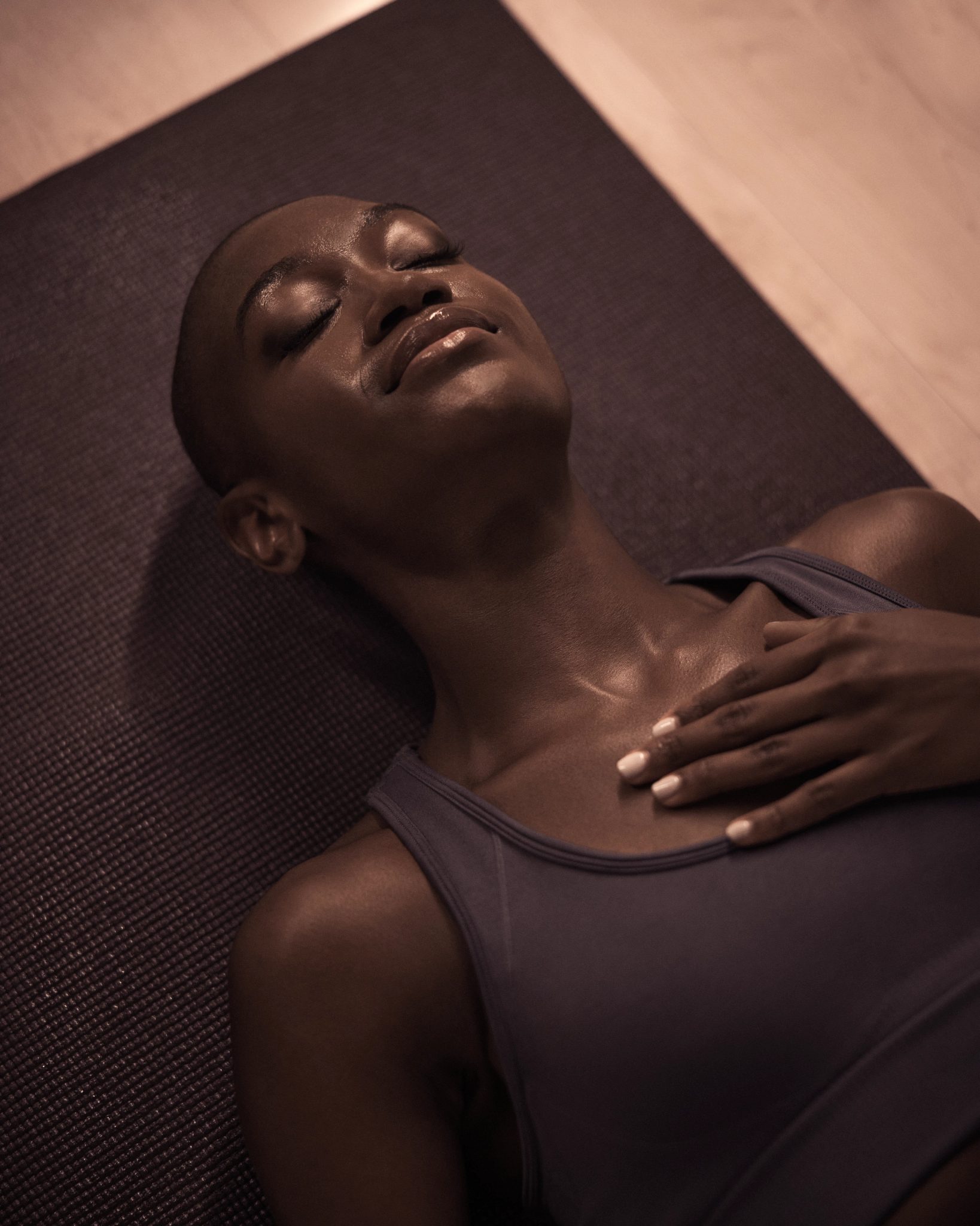 Life Time member laying on their mat at the end of a MB360 boutique group training class