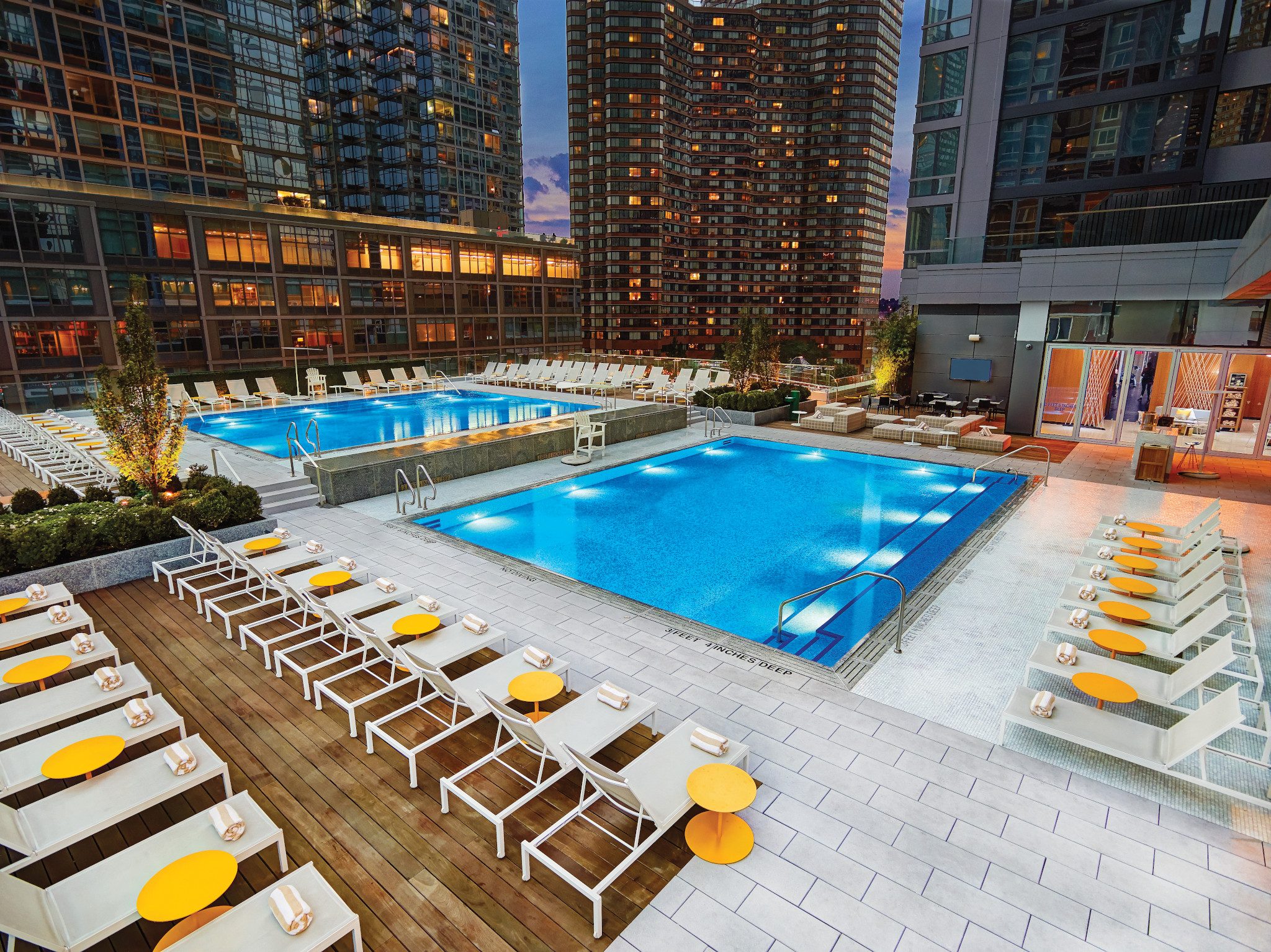 The rooftop pool deck at Life Time Sky at dusk