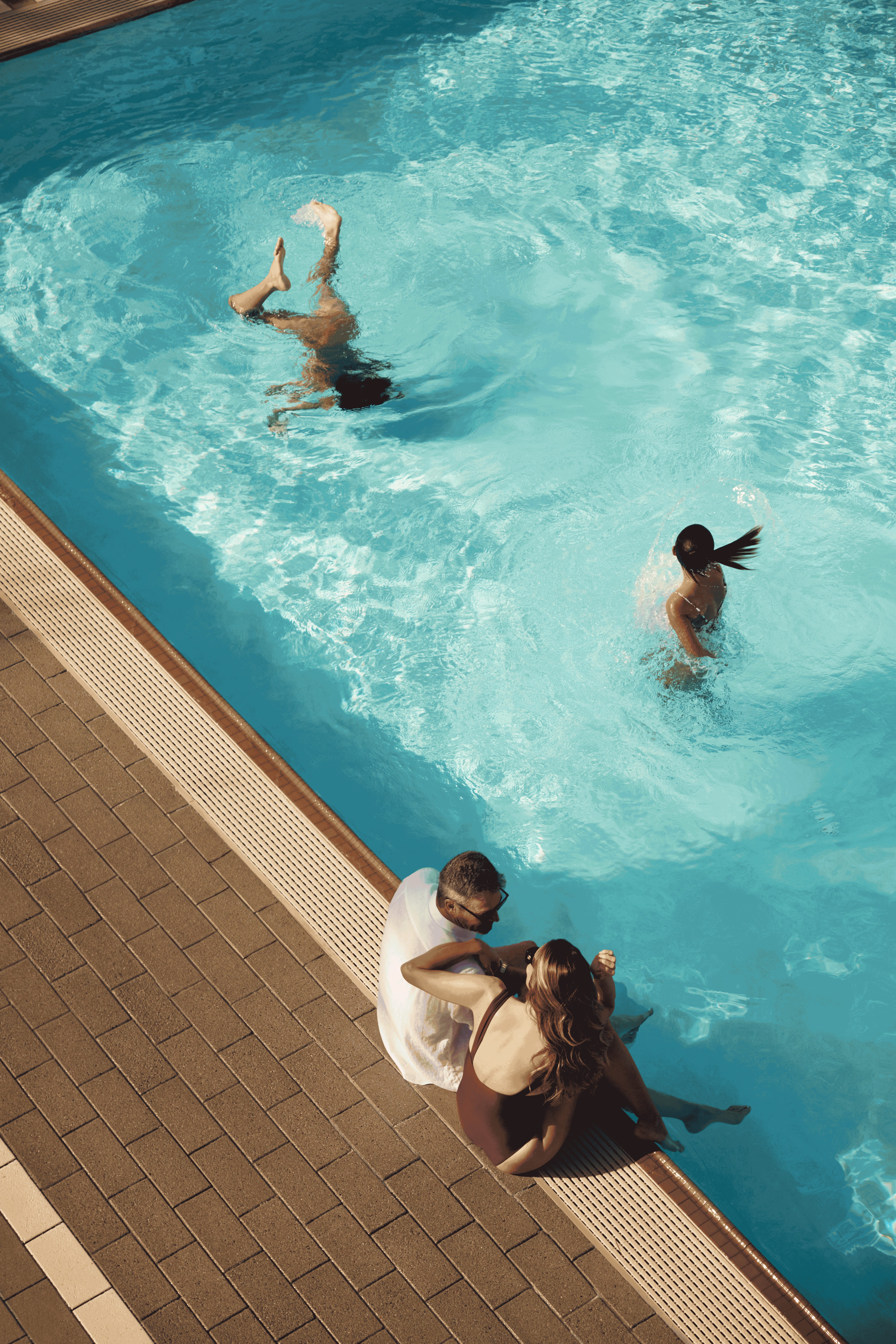 family swimming in a pool