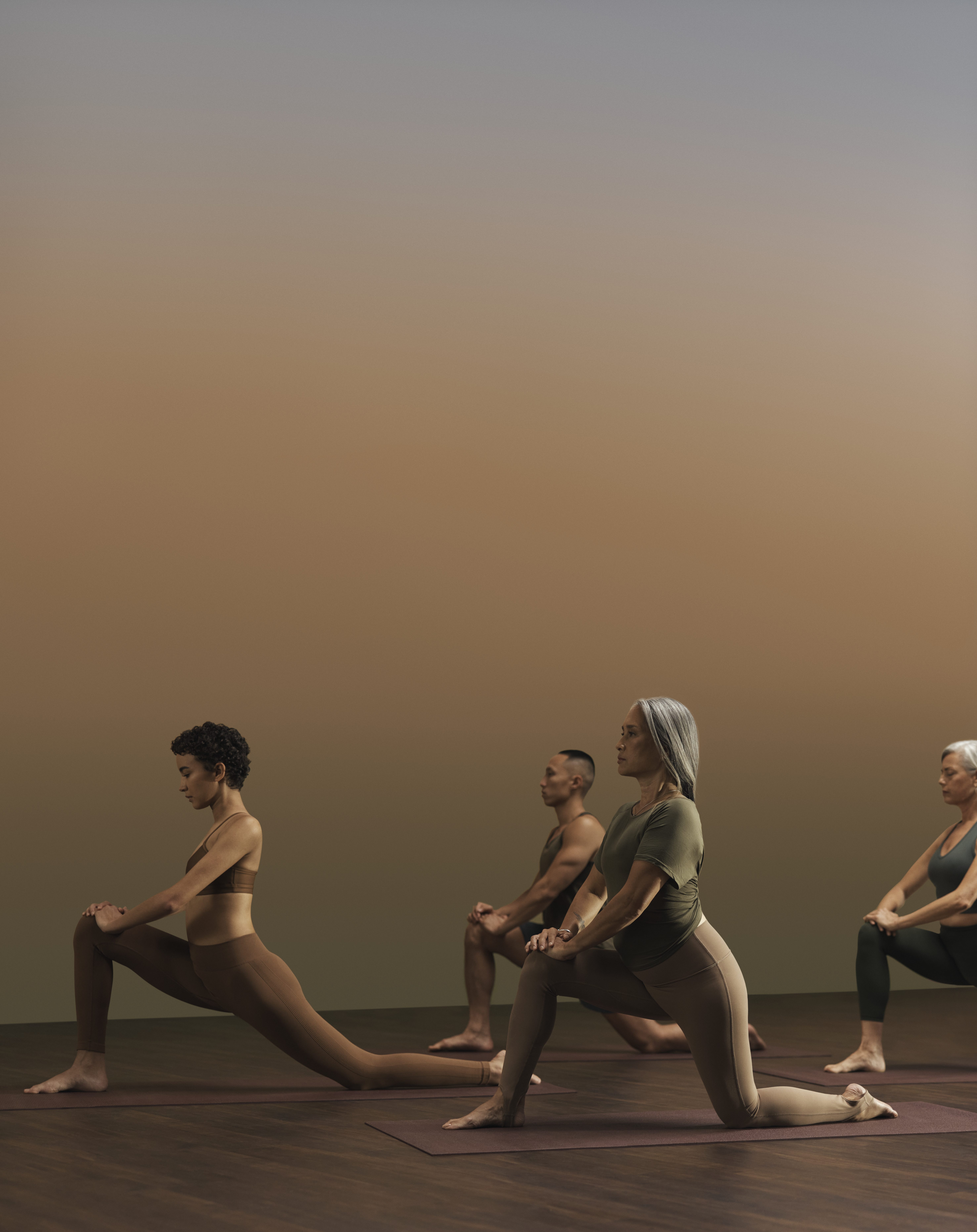 Yogis in low lunge pose during a yoga class at Life Time