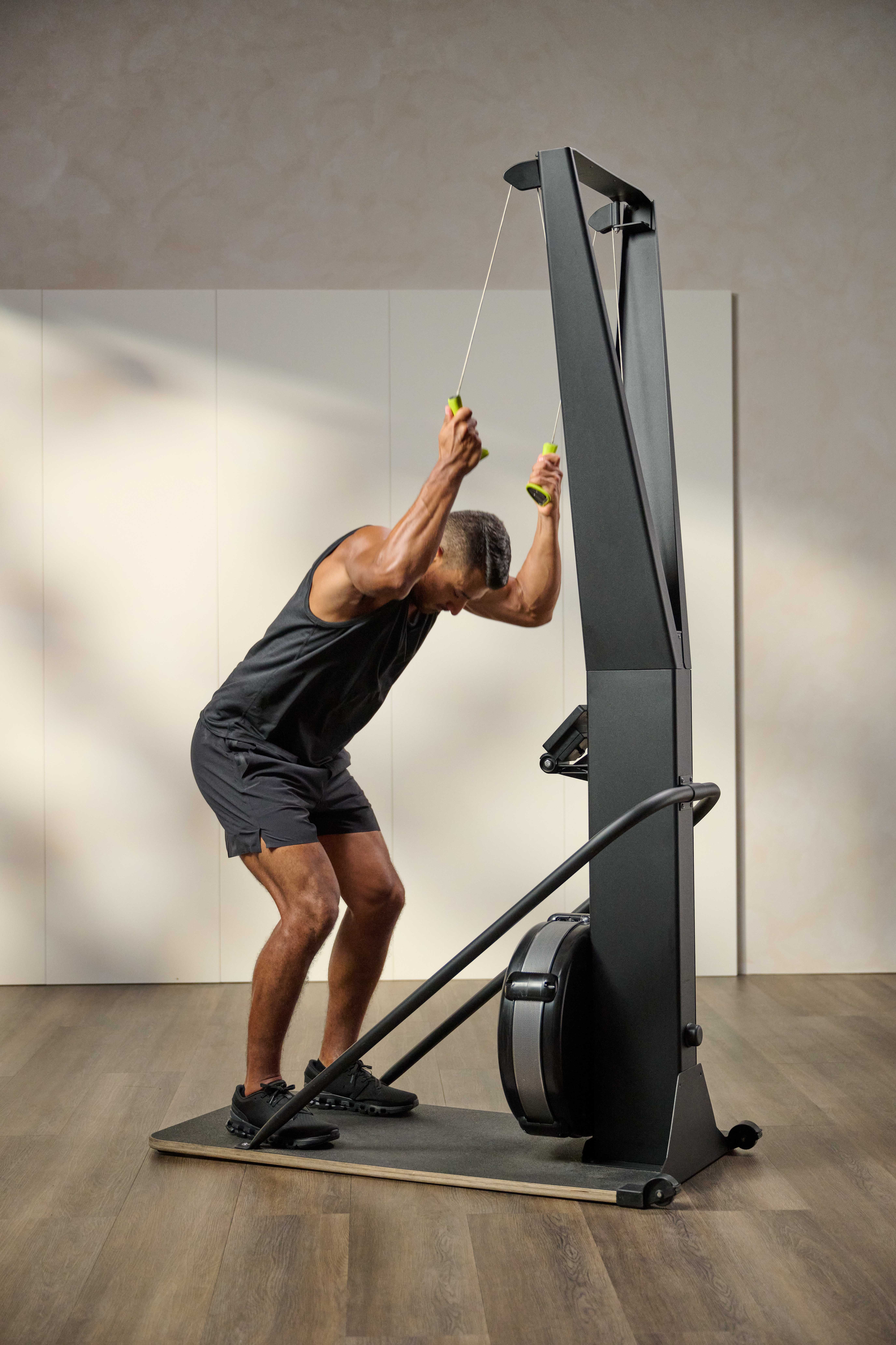 man using an upright rows machine