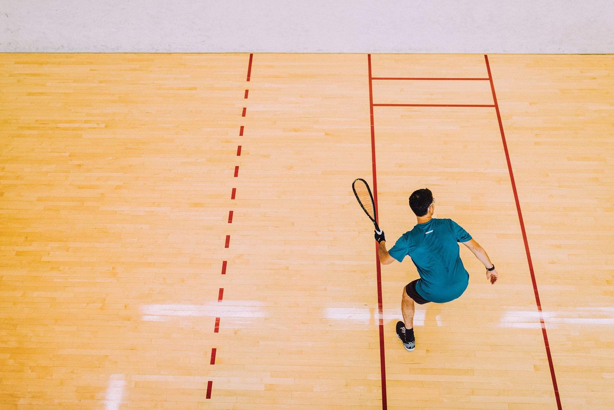 An aerial view of a man playing squash