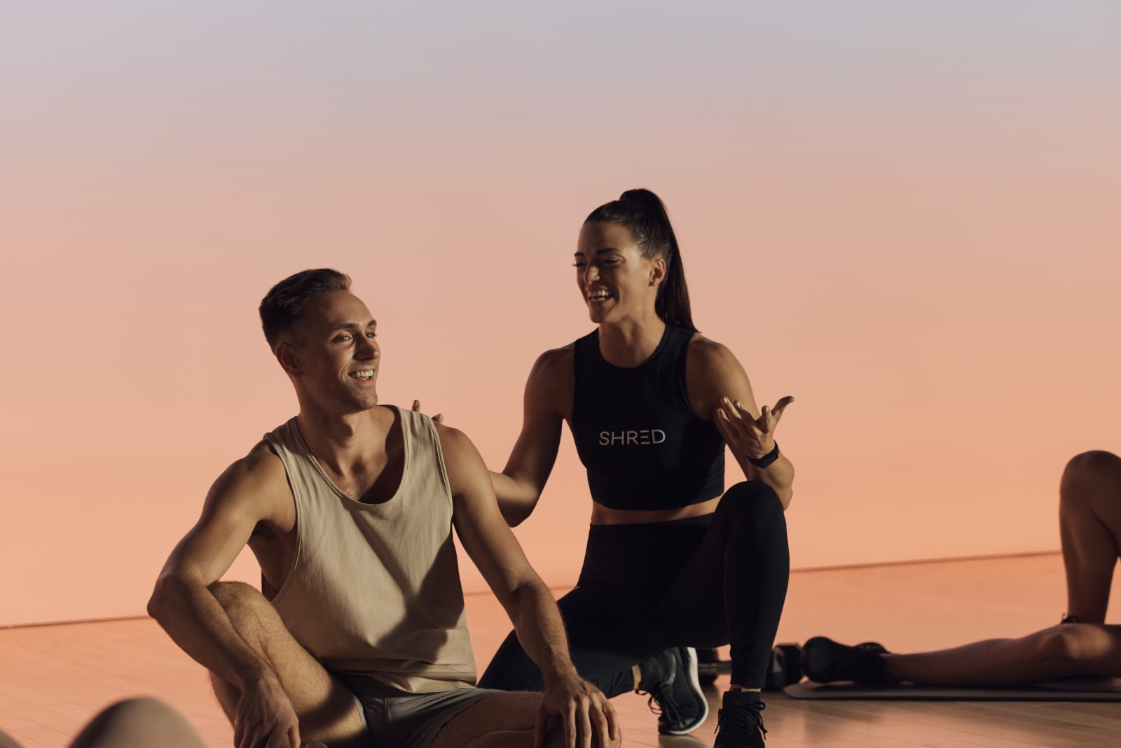 Instructor coaching a member during a Shred strength class