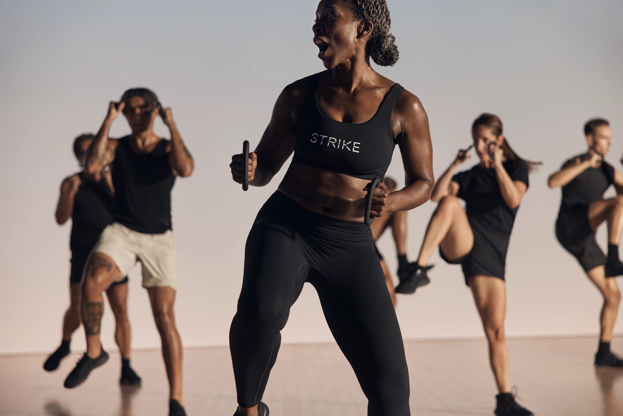 Strike kickboxing martial arts class participants being led by an instructor at Life Time