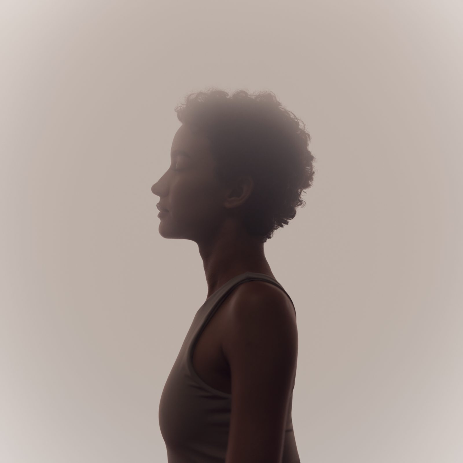 Stylized profile of a woman in a surrender yoga class at Life Time