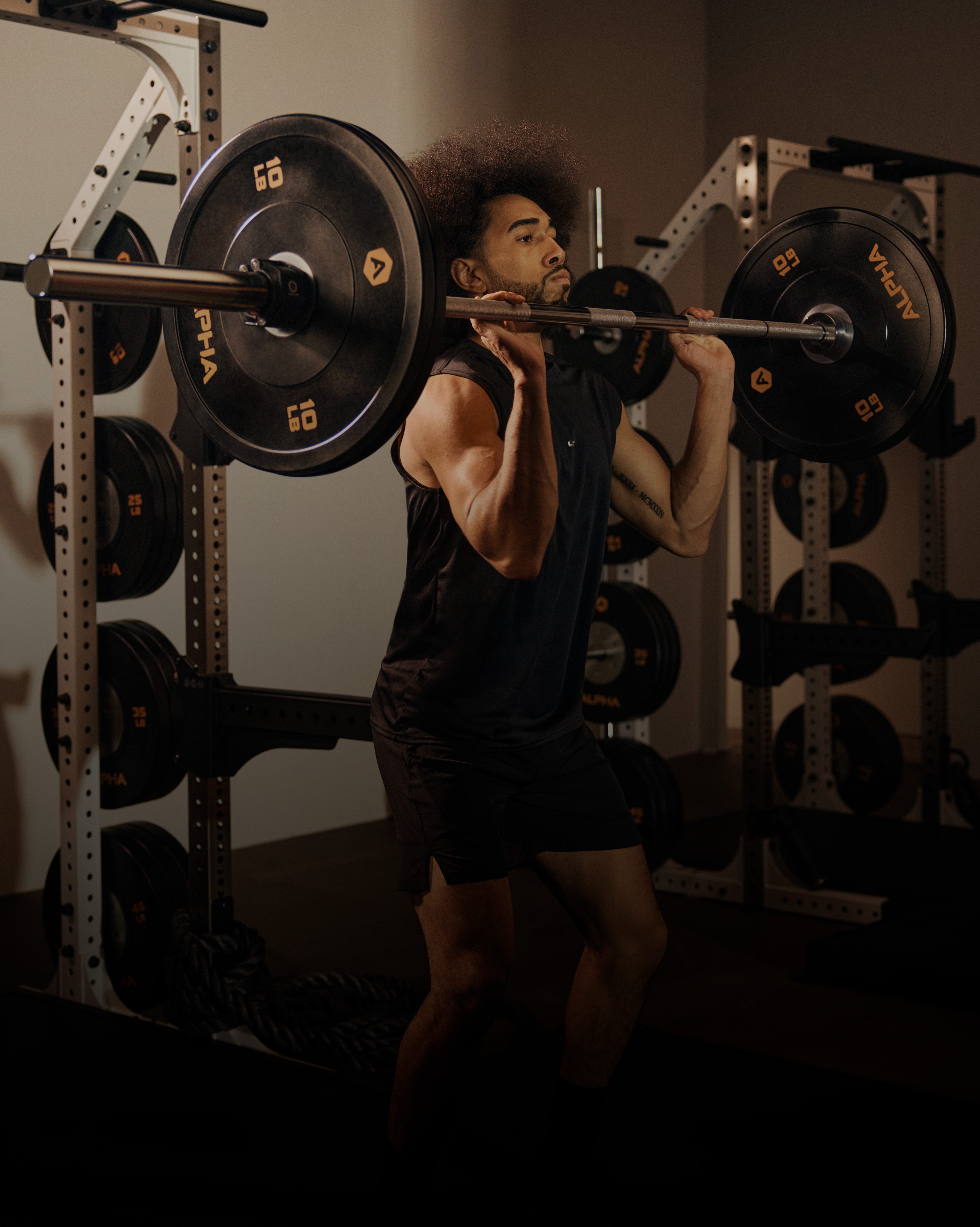 Man working out lifting weights with a dumbbell bar