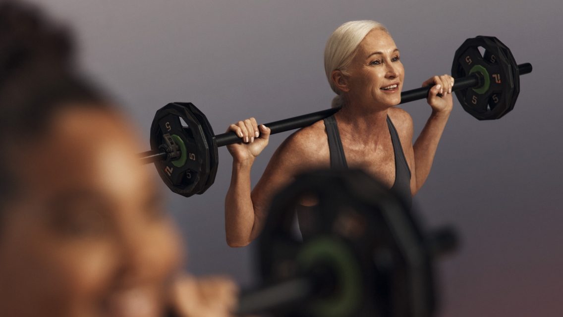 a woman lifting weights with a light weight barbell