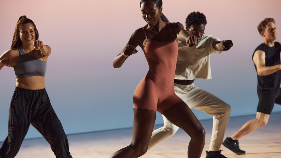 a group of people dancing in a workout class
