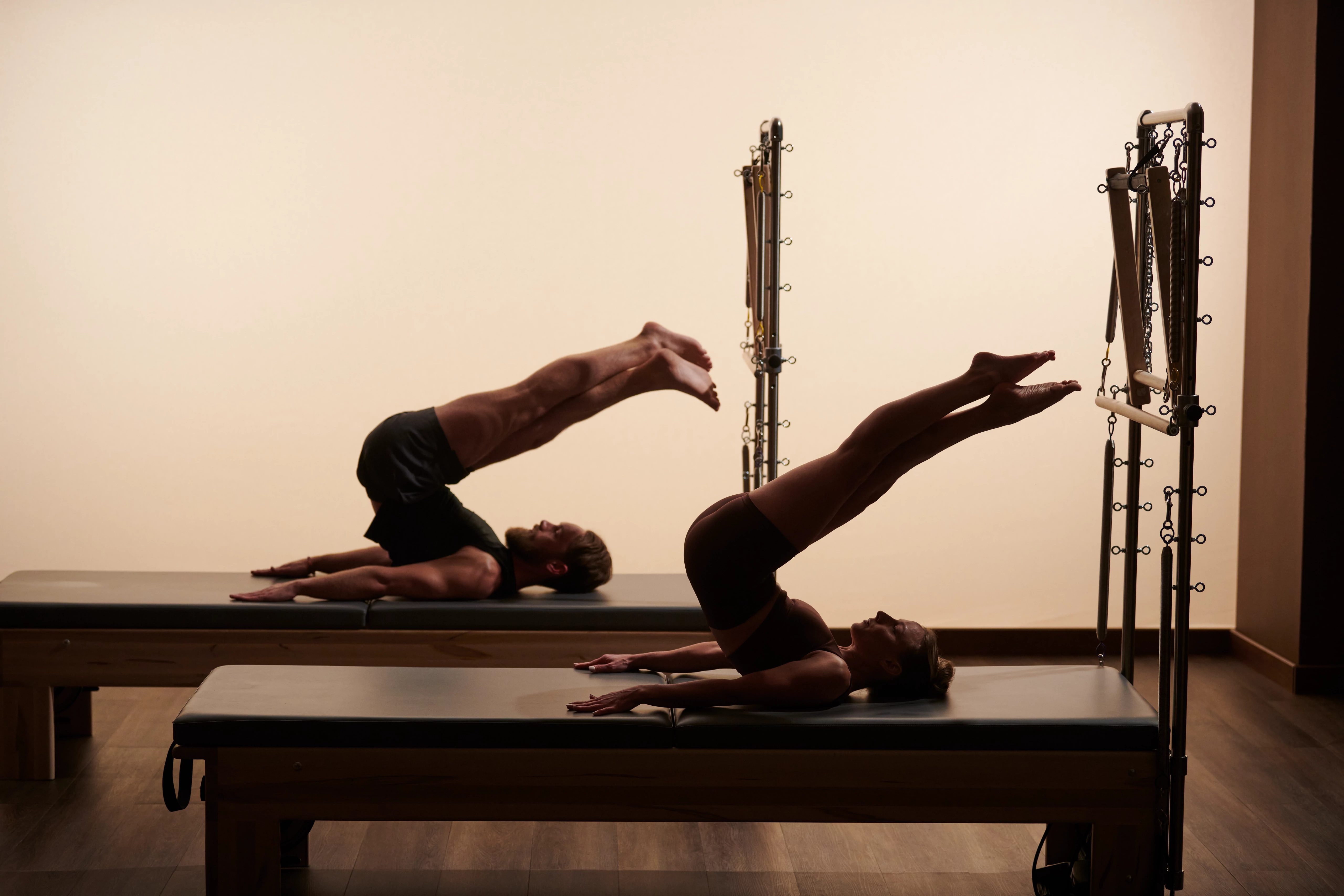 Life Time members exercising on reformers during a Pilates class