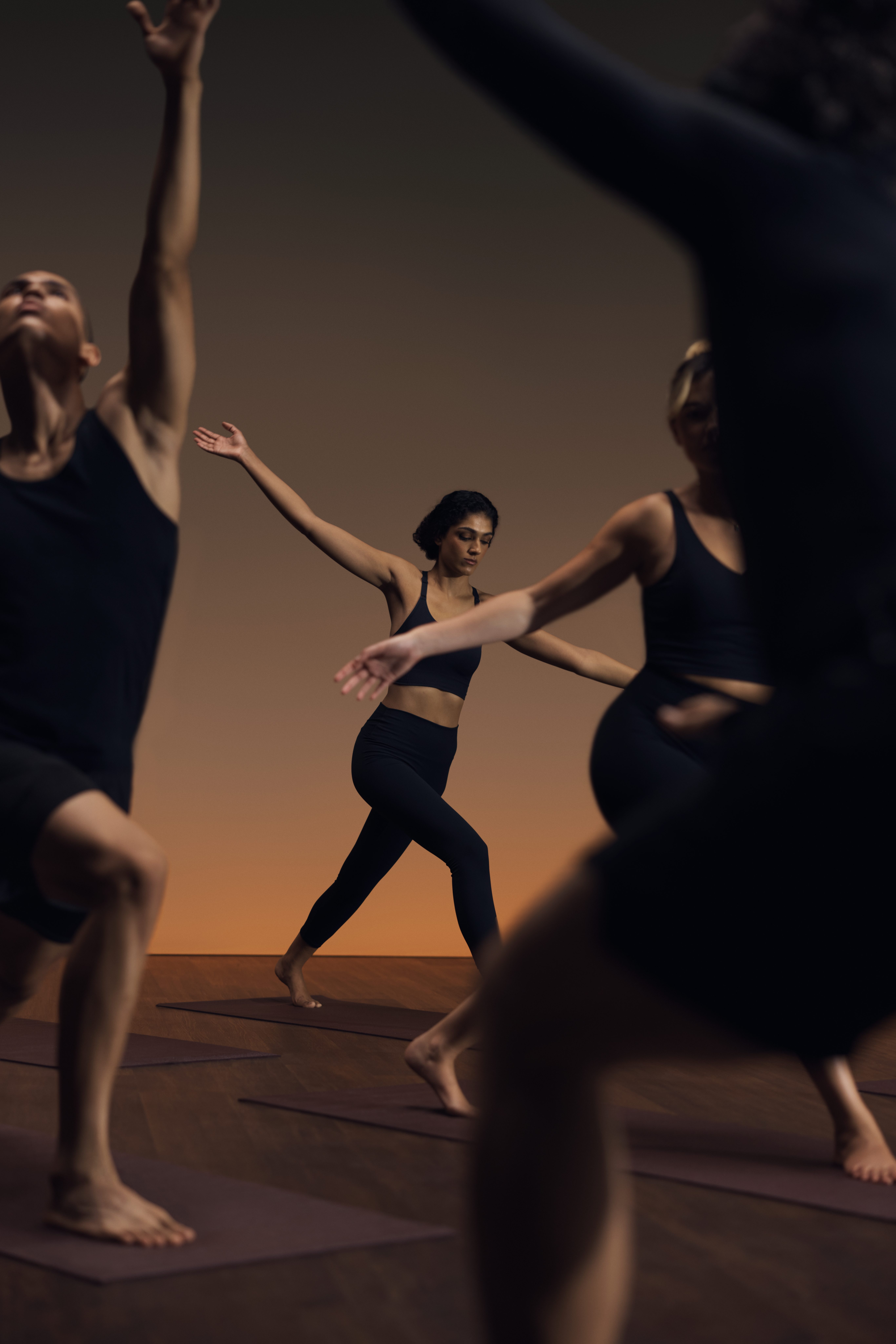 Flow yoga class participants in varying poses at Life Time
