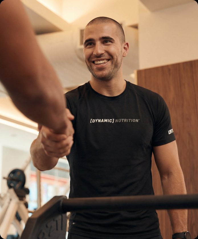 a Dynamic Nutrient coach shaking hands with a member