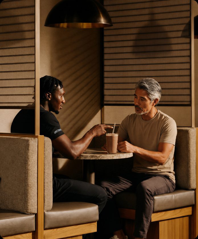 a member and coach having a conversation at the Life Cafe